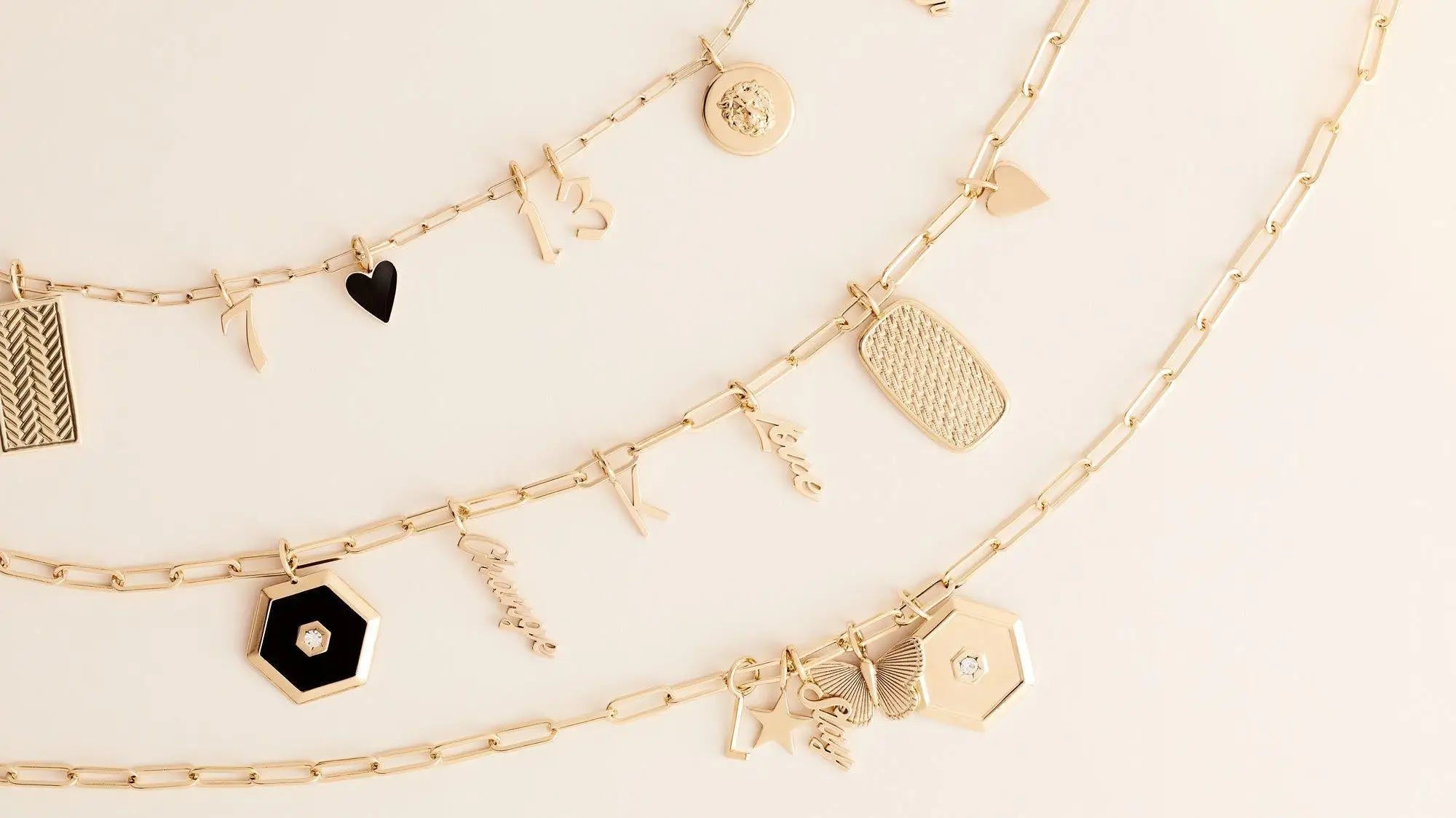 Gold charm necklaces from the Personalized Jewelry collection hanging on display