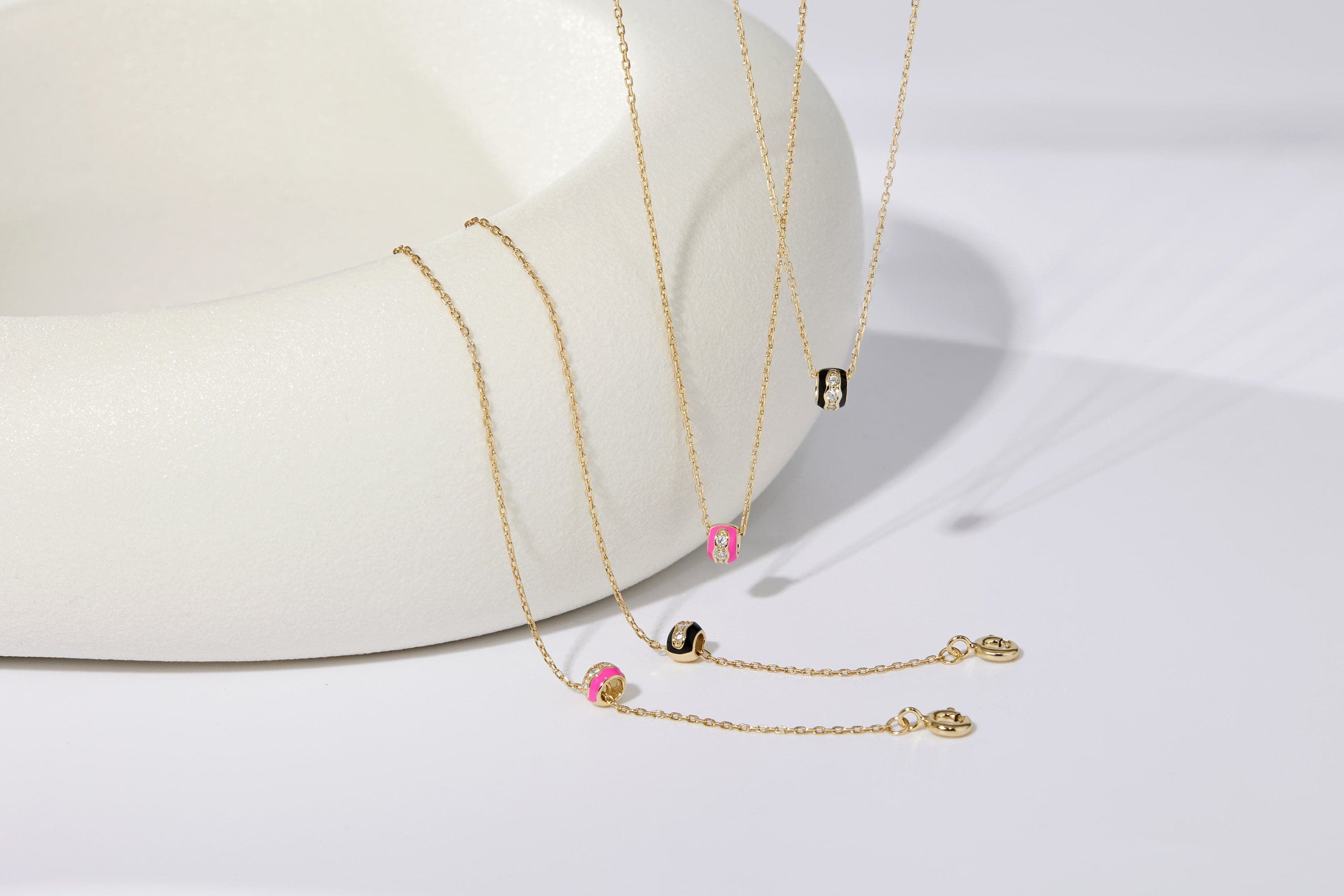 Gold necklaces with colorful cylindrical pendants from Black Enamel & CZ Channel Rondelle Necklace