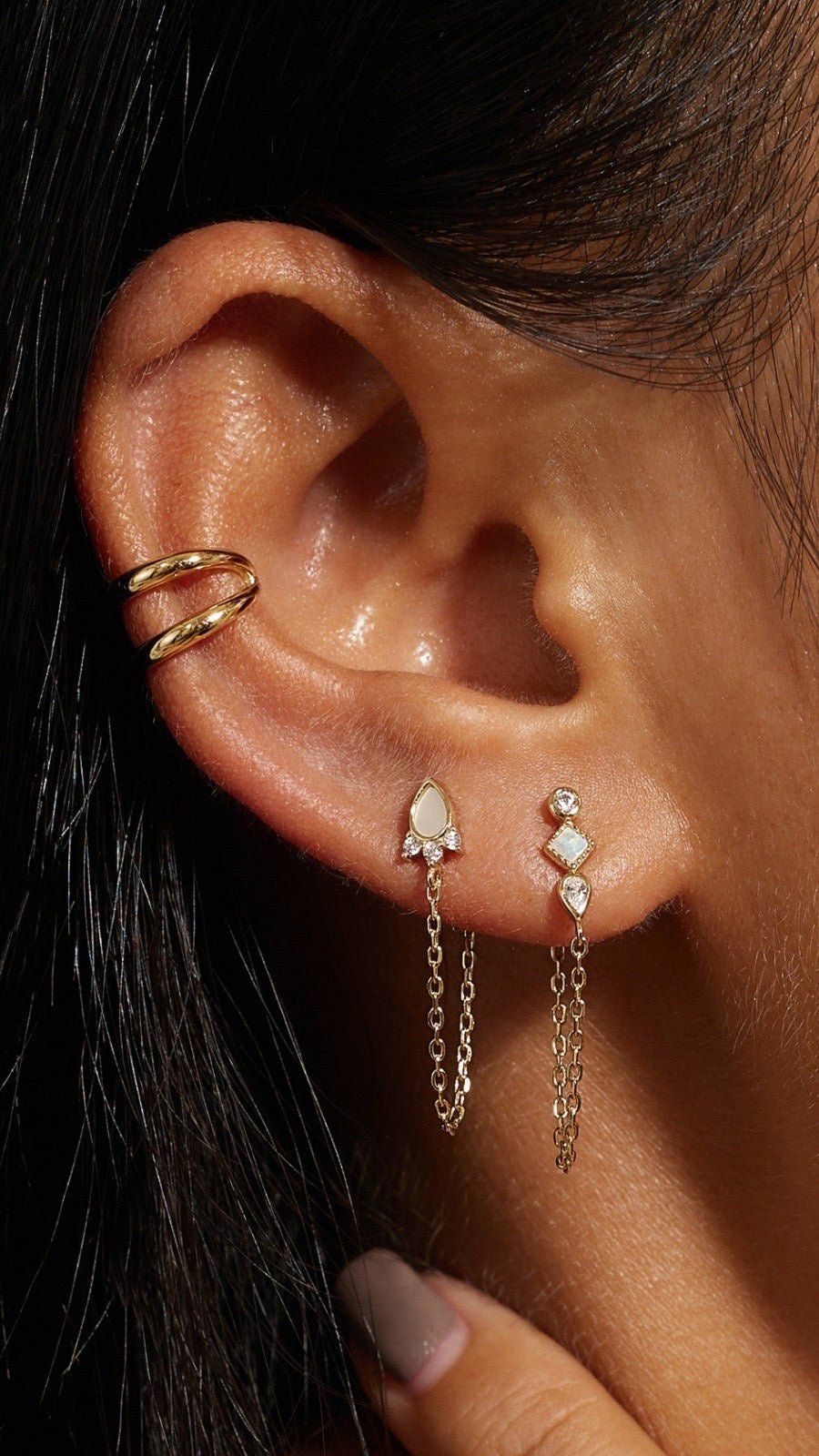 Close-up of a ear with gold jewelry wearing a Double Ear Cuff for stylish vibes