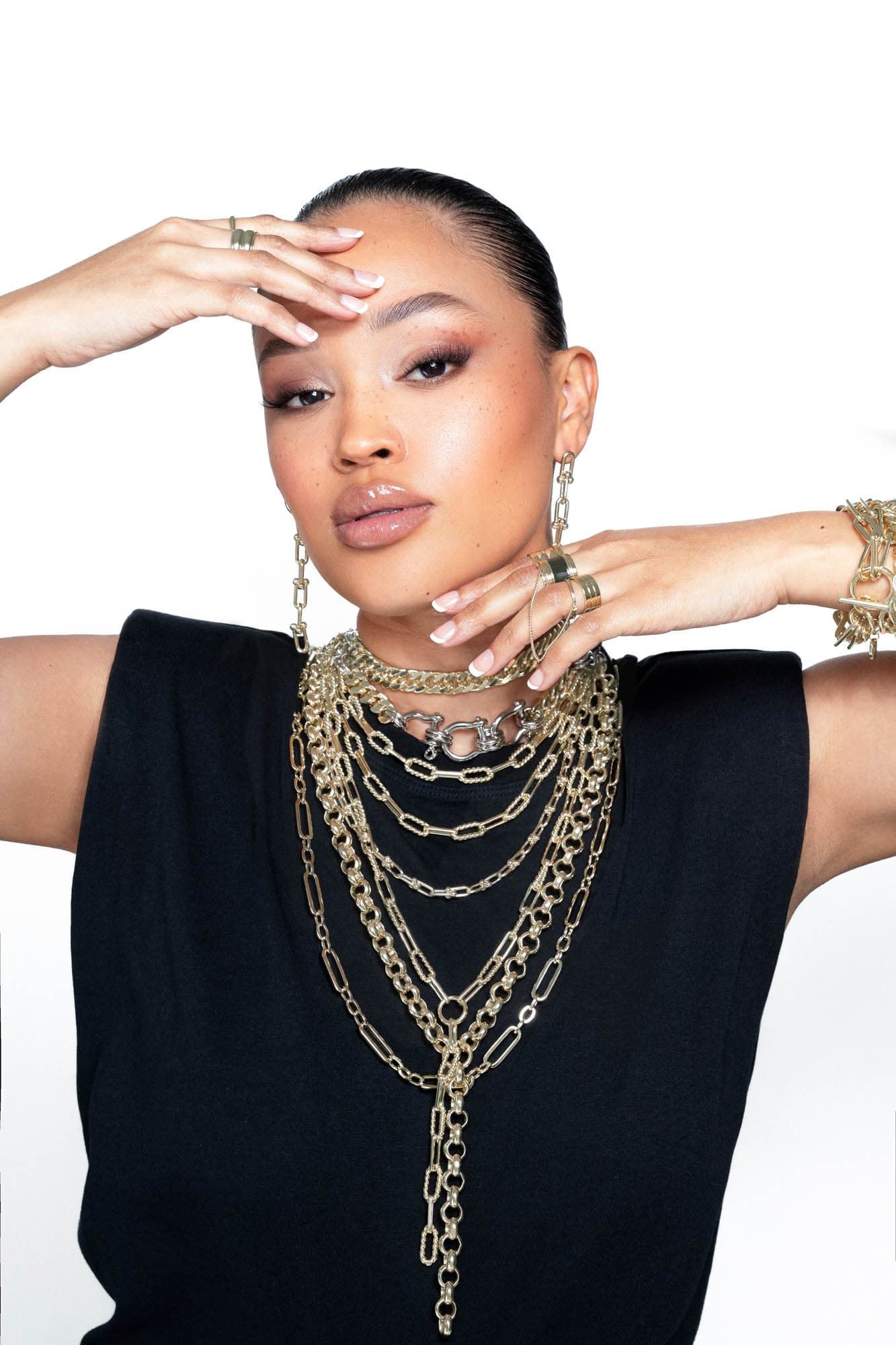 Woman wearing the stylish Dean Lariat Necklace with layered gold necklaces