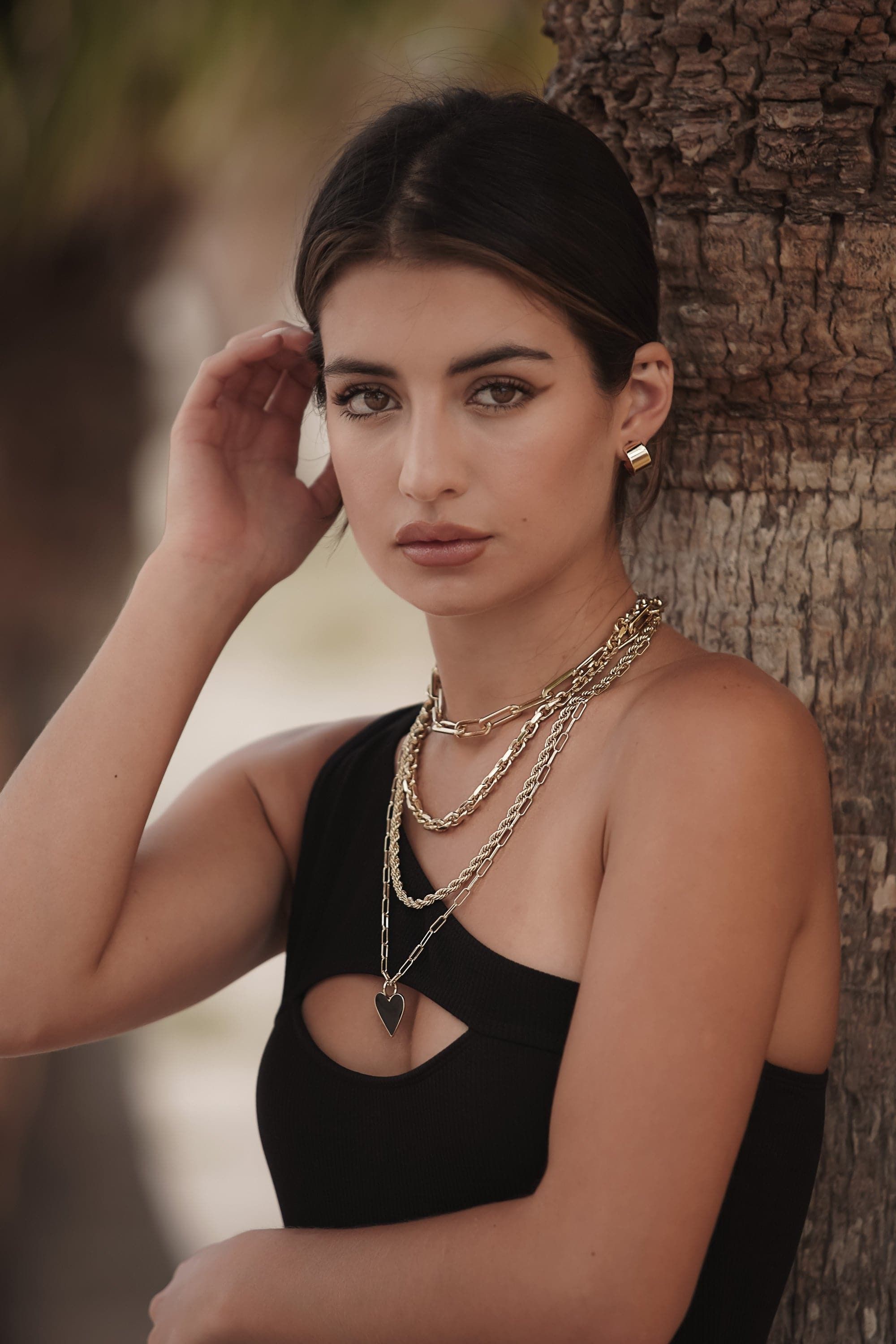 Woman rocking the stylish Gianni Necklace with shiny gold layered chains