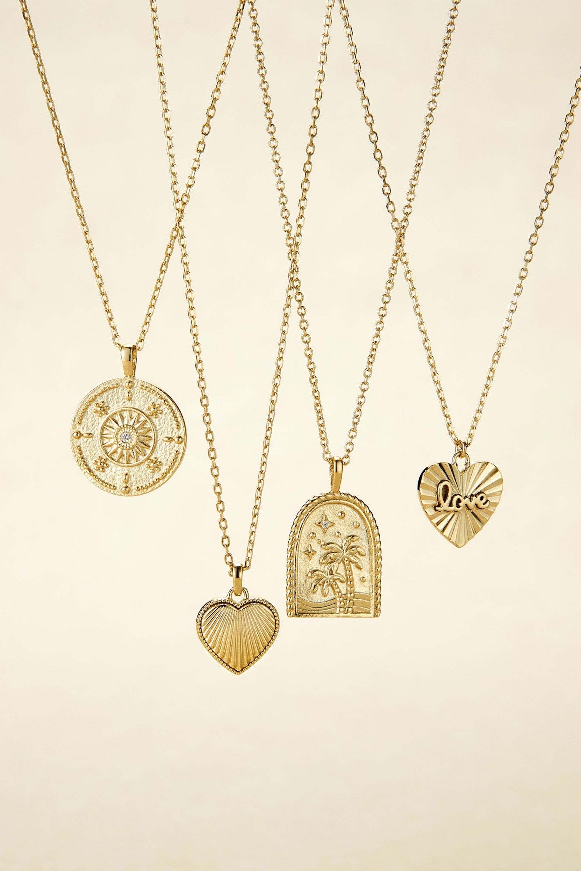 Five gold-tone necklaces with unique pendants from the Mini Love Heart Charm Necklace collection