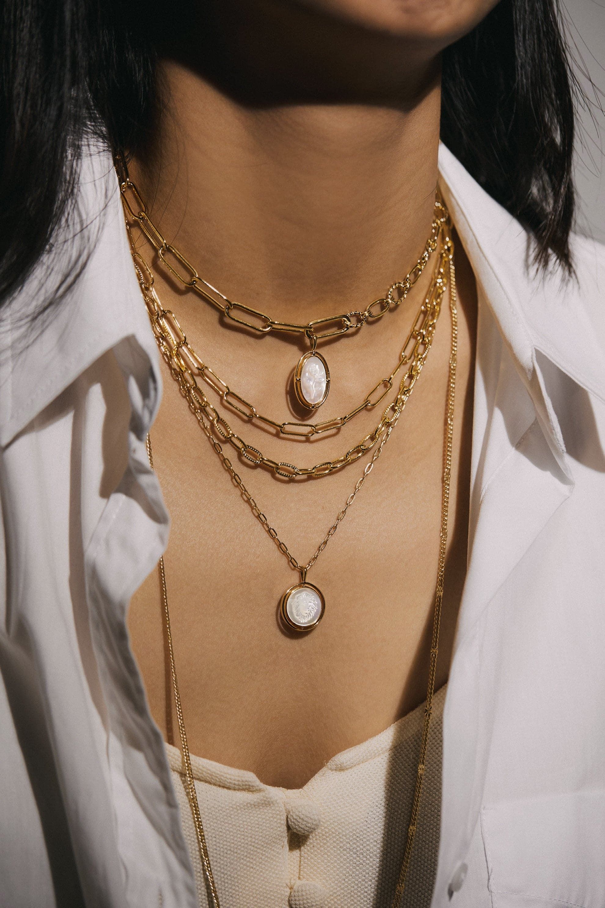 Layered gold necklaces with Mother Of Pearl Lion Pendants for a stylish look