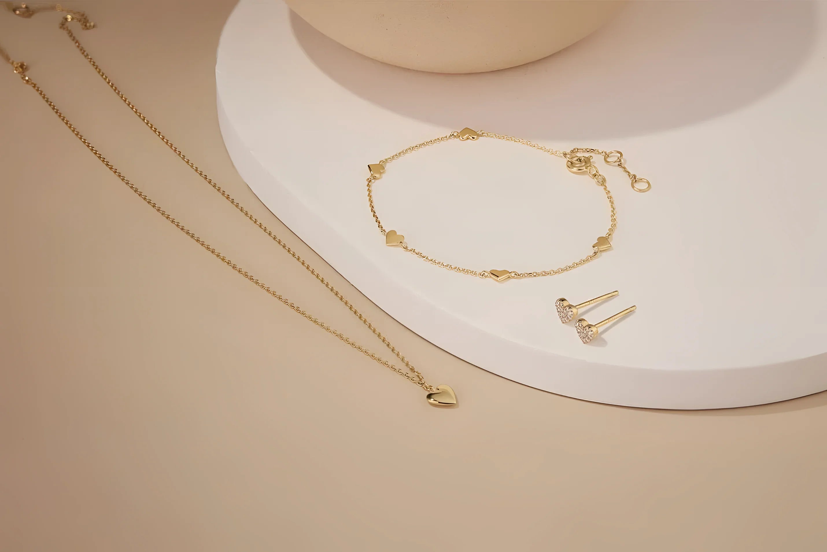 Gold jewelry set featuring the stylish Multi Micro Heart Bracelet for a trendy look