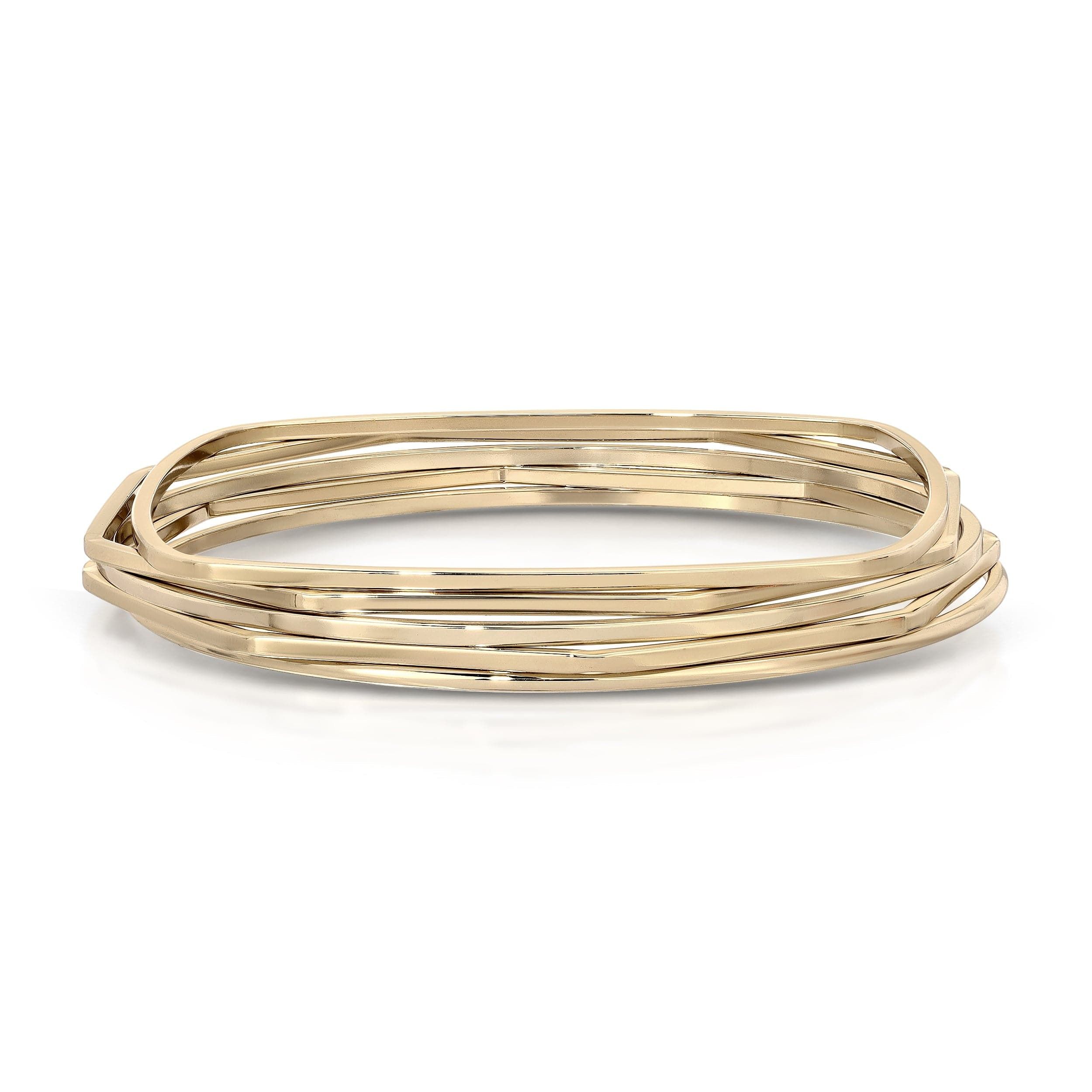 Stack of shiny gold square bangles from the Skinny Bangle Set for trendy wrist wear