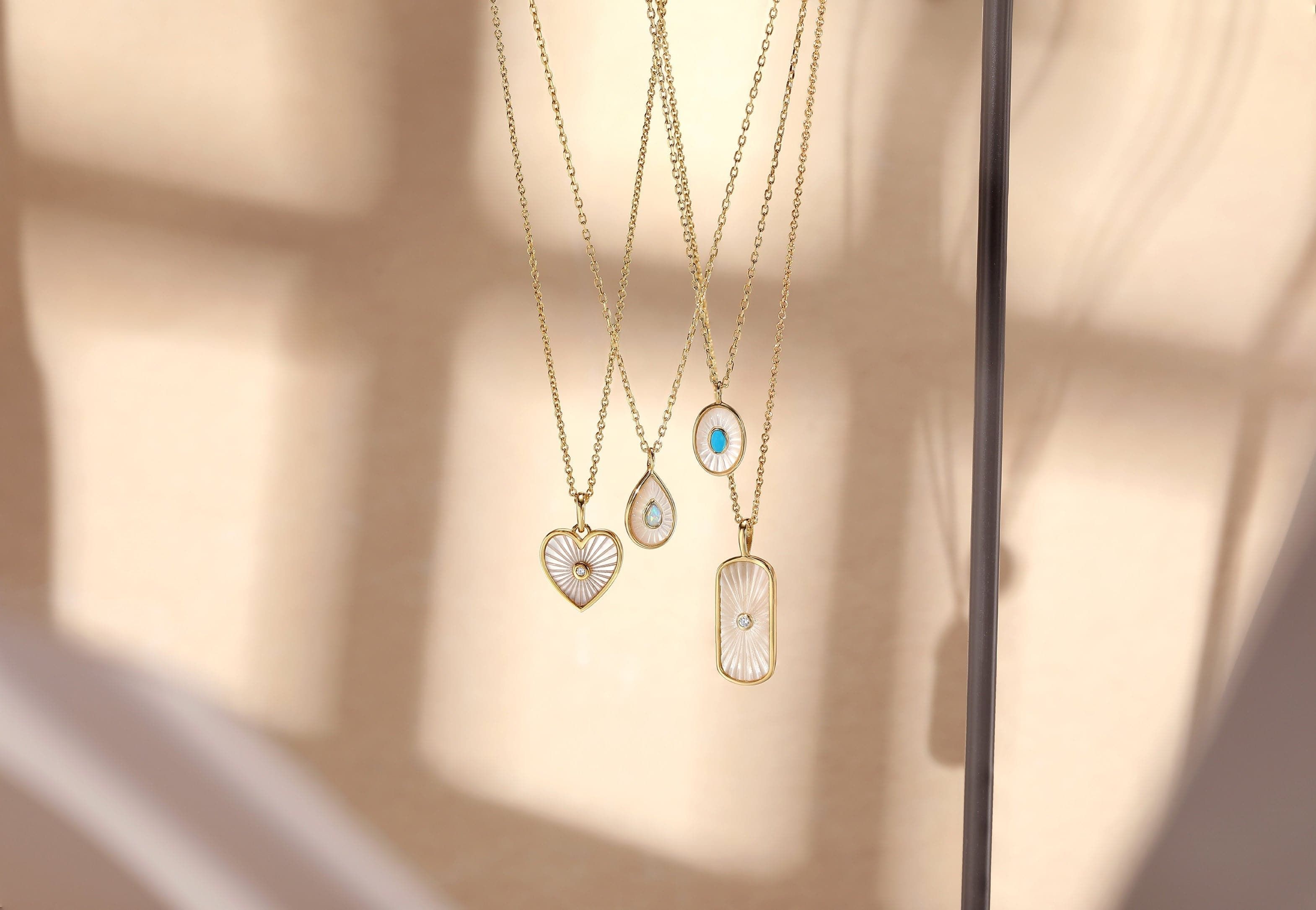 Gold necklaces with decorative tag shaped Mop pendant and CZ stones for stylish looks
