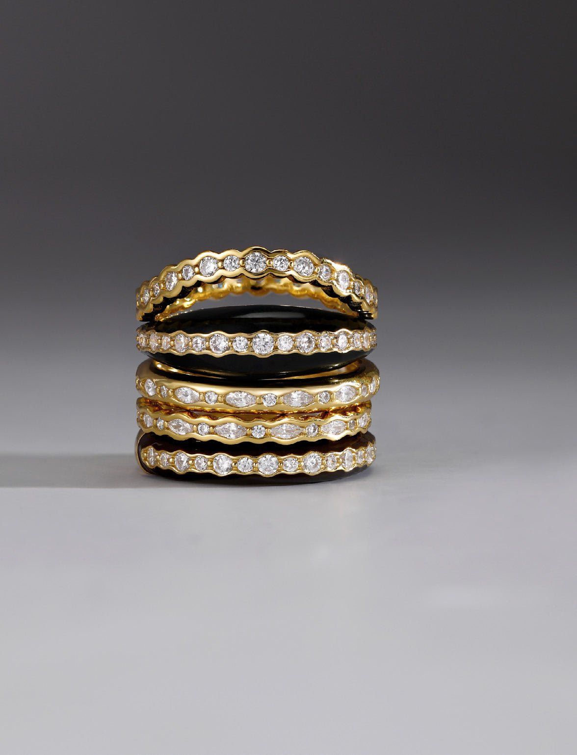 Stacked gold and diamond eternity rings for the Thin Black Enamel & CZ Channel Ring product