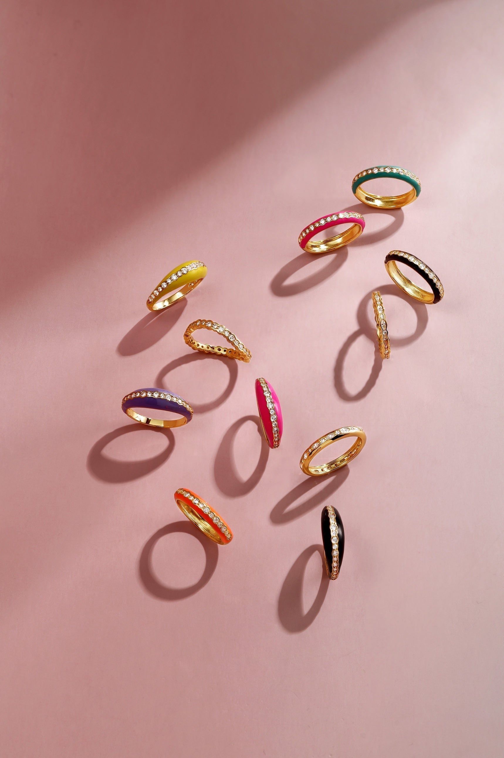 Colorful enamel and diamond rings in a Thin Black Enamel and CZ Channel Ring display