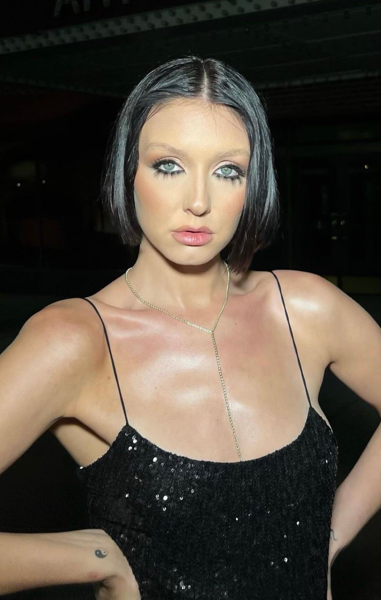 Woman in shiny sequined dress wearing the Thin Luciana Box Chain Lariat necklace