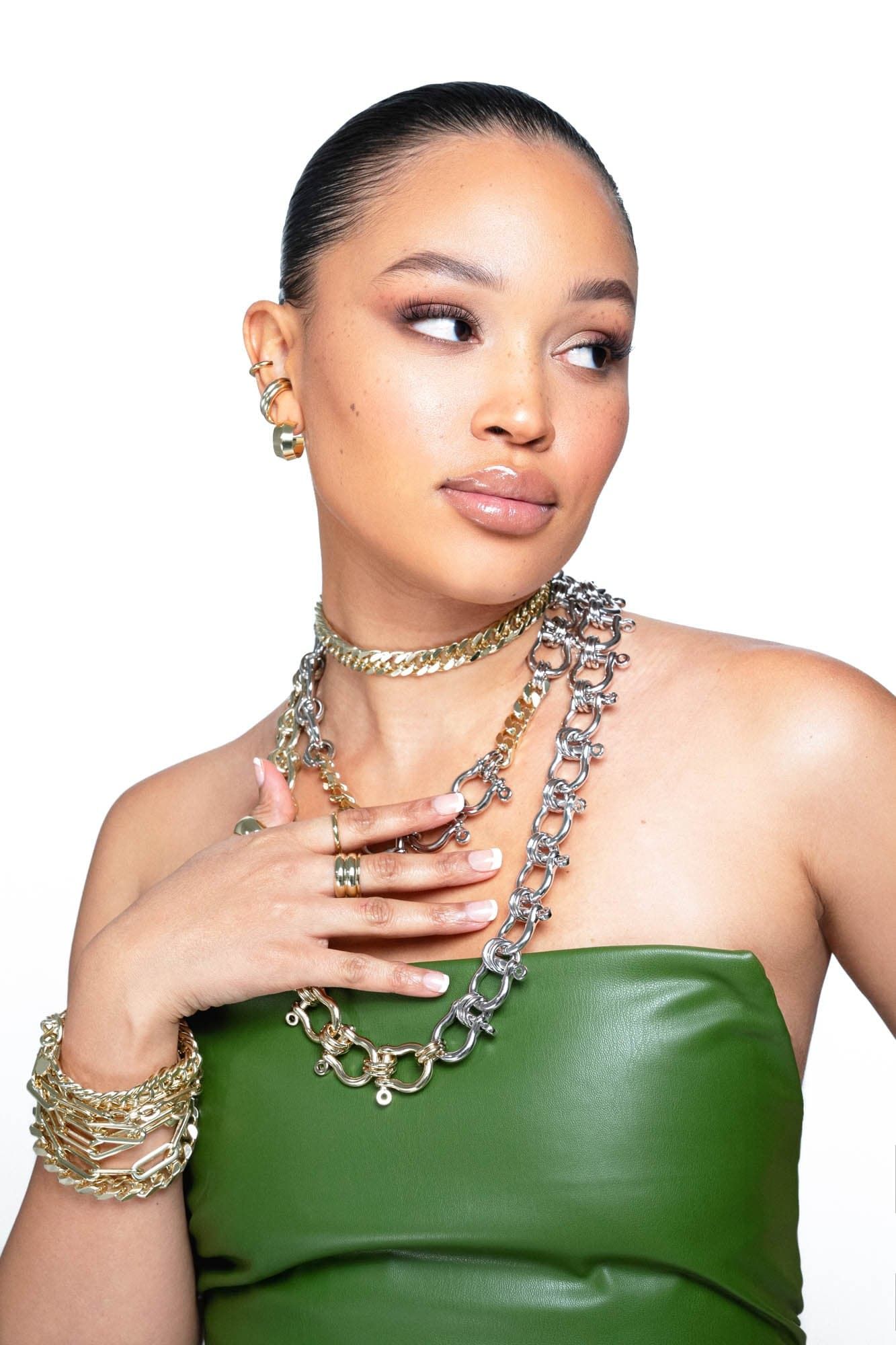 Woman showing off layered jewelry with the Two Toned XL Harrison Necklace