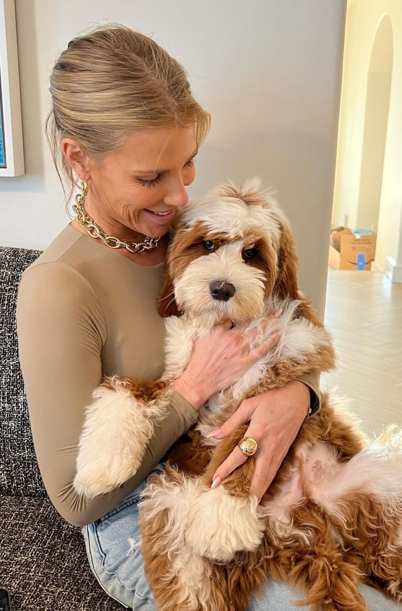 Woman holding a brown and white dog showcasing the XL Alternating Twisted Link Toggle Necklace