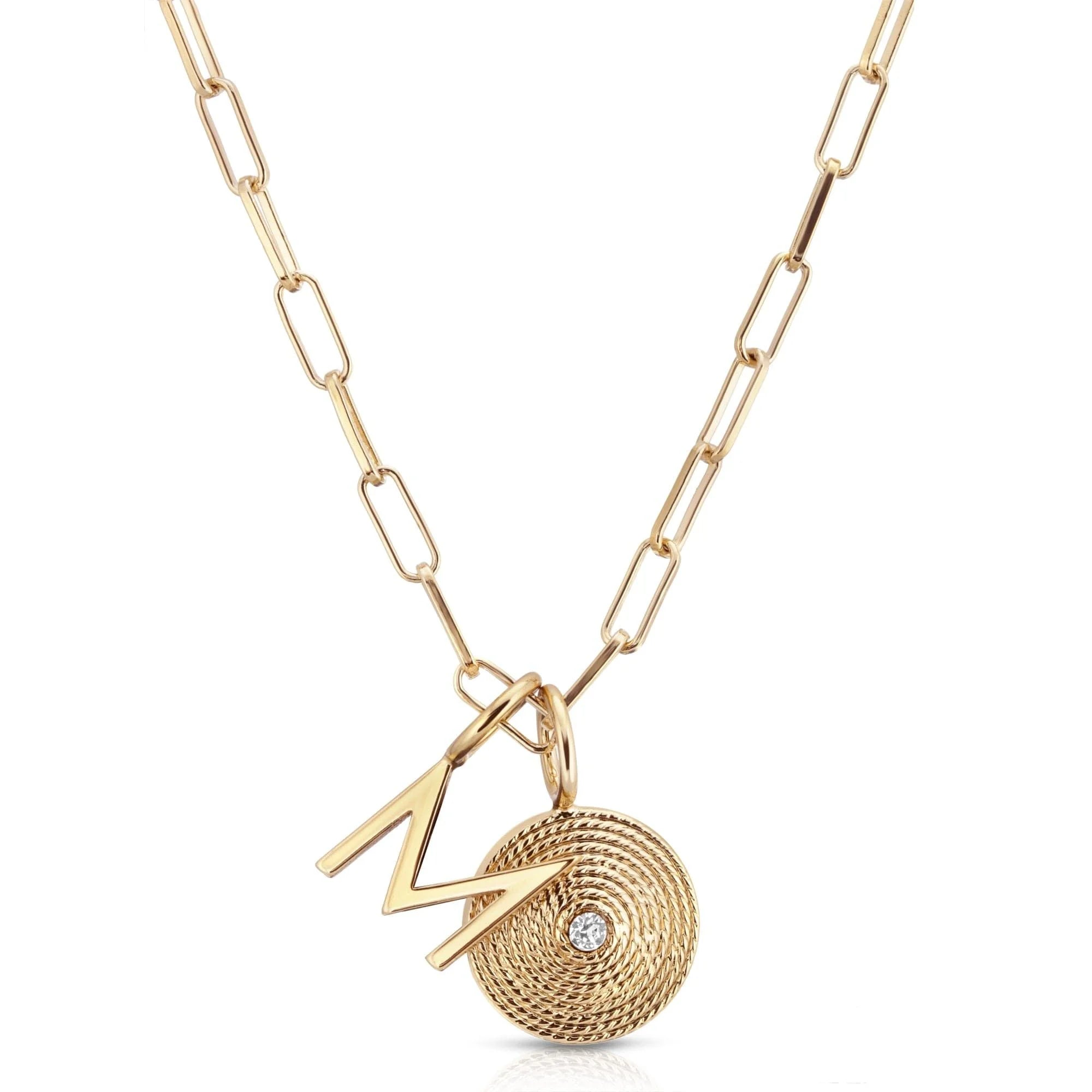 Gold catherine charm necklace with elongated link chain and Zena pendant featuring letter and disc charms