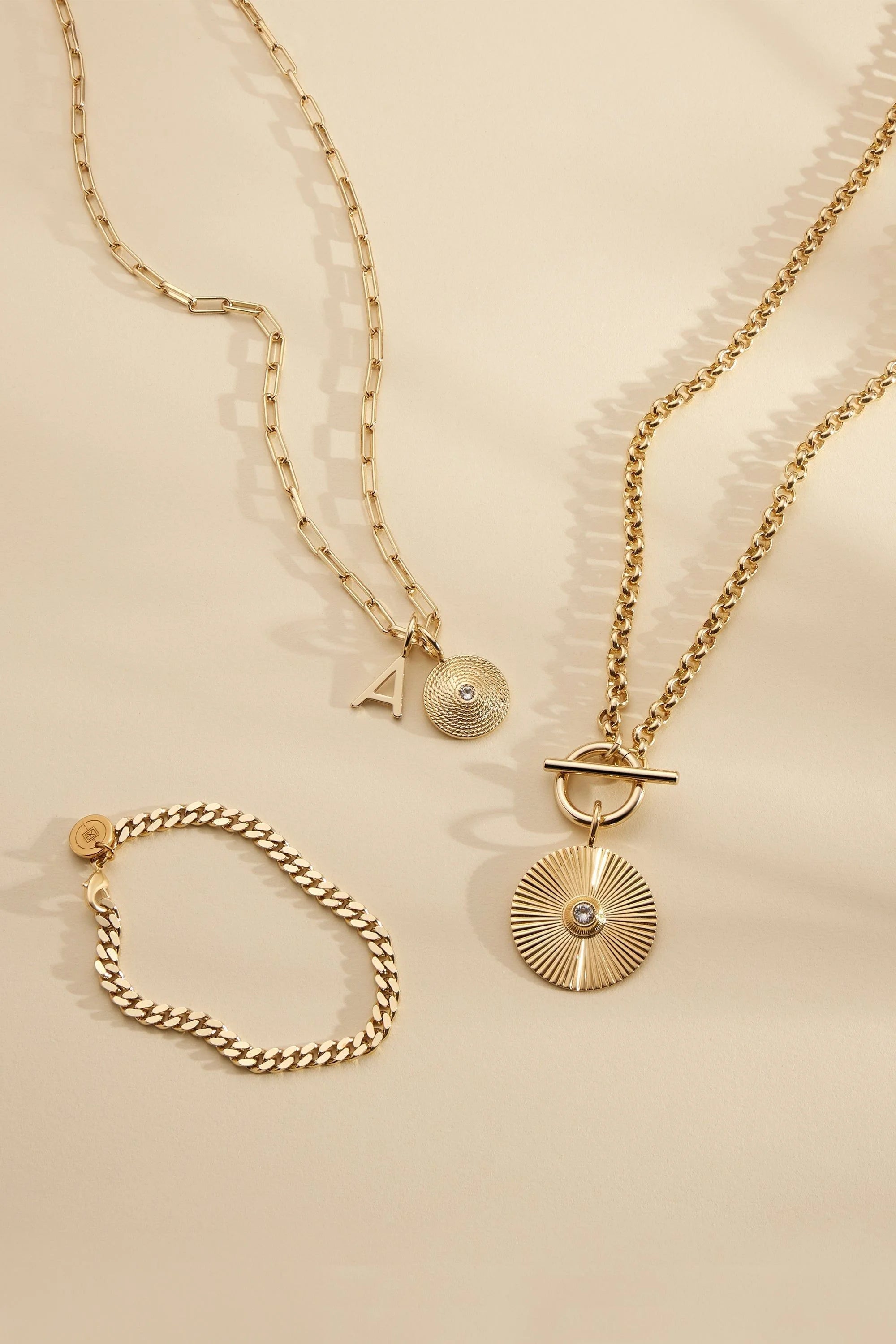 Gold-toned jewelry set with catherine charm necklace featuring elongated link chain and Zena pendant