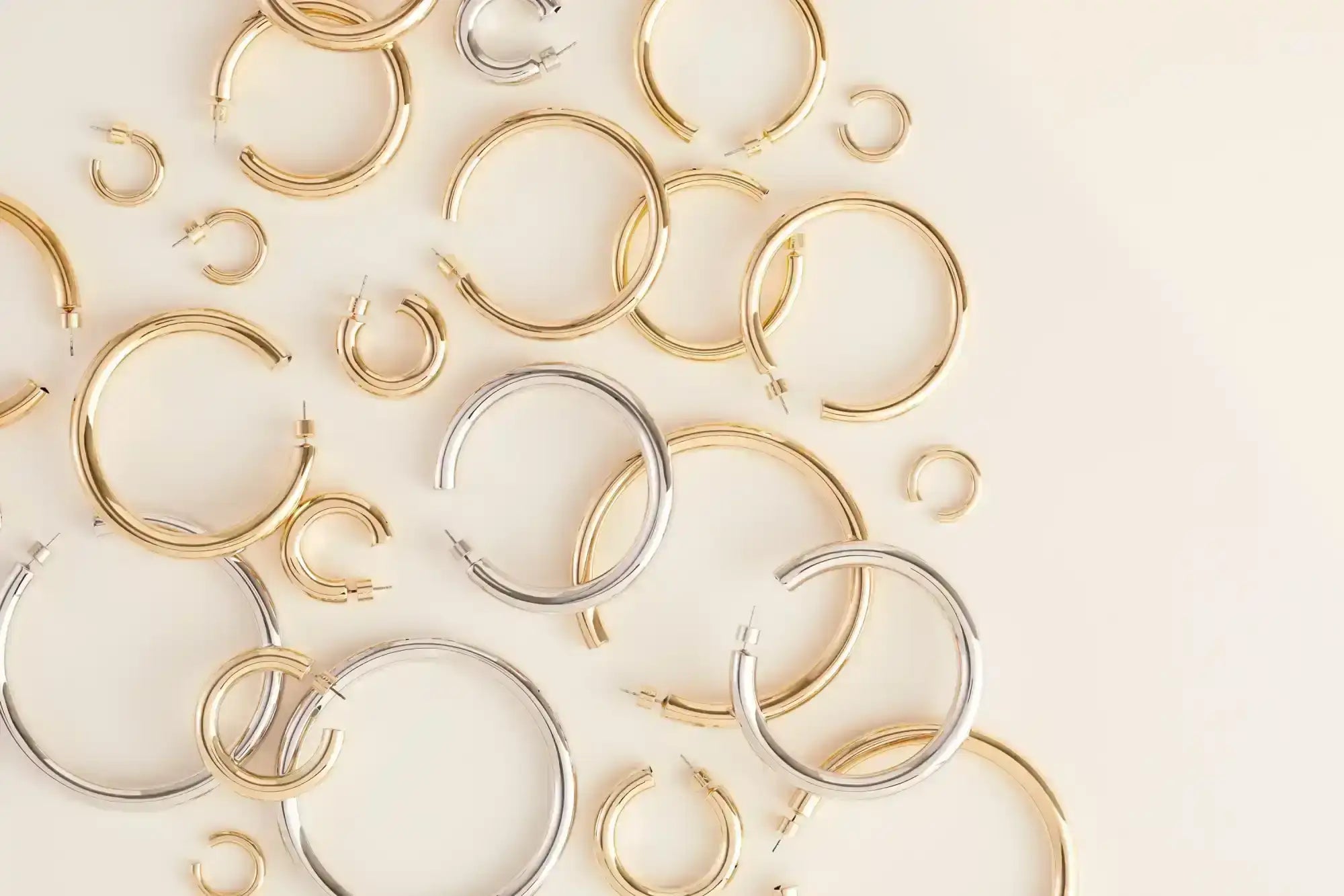 A collection of gold and silver hoop earrings.