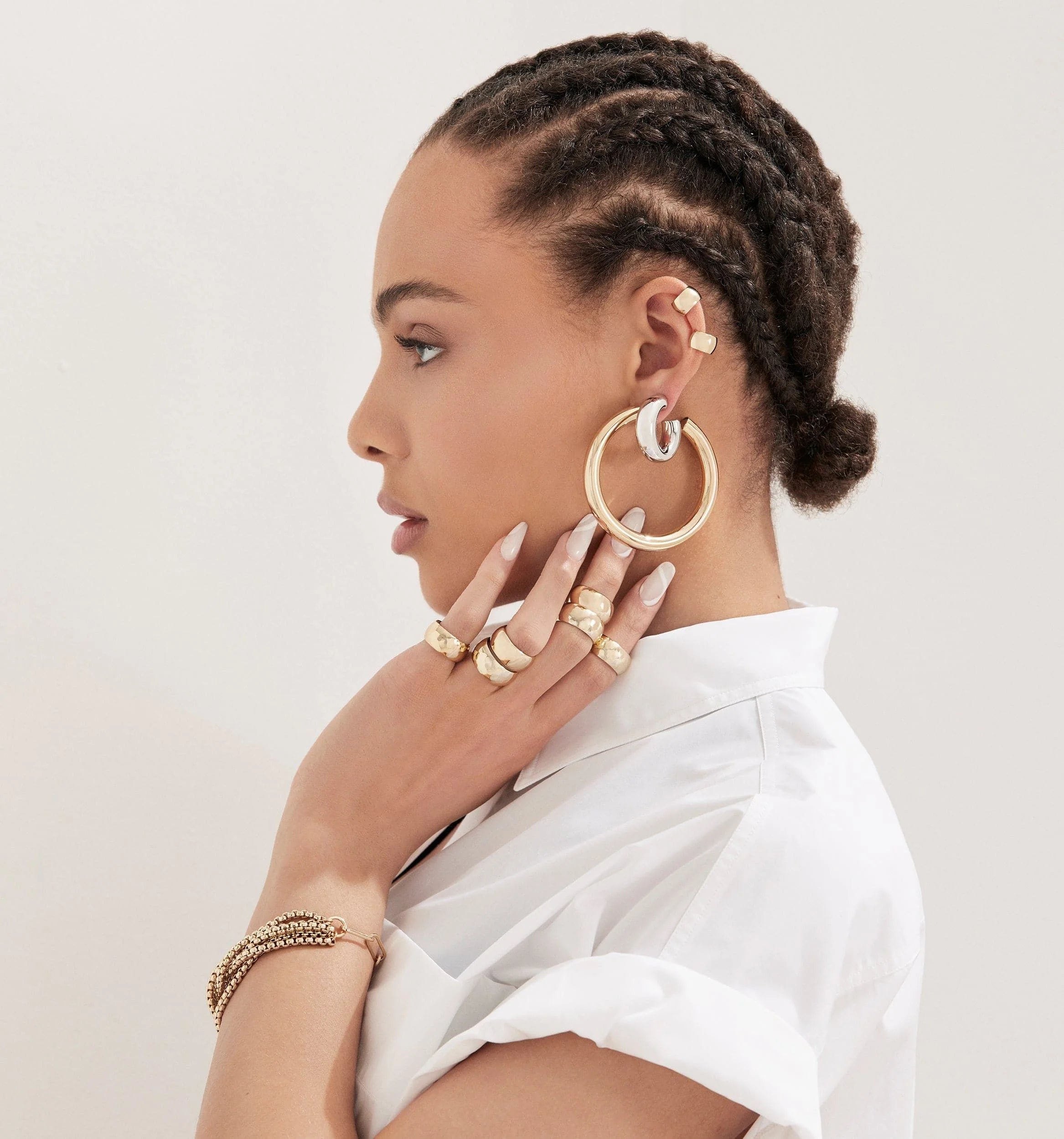 Woman showing off gold jewelry in 2 inch Ryan Hoops earrings