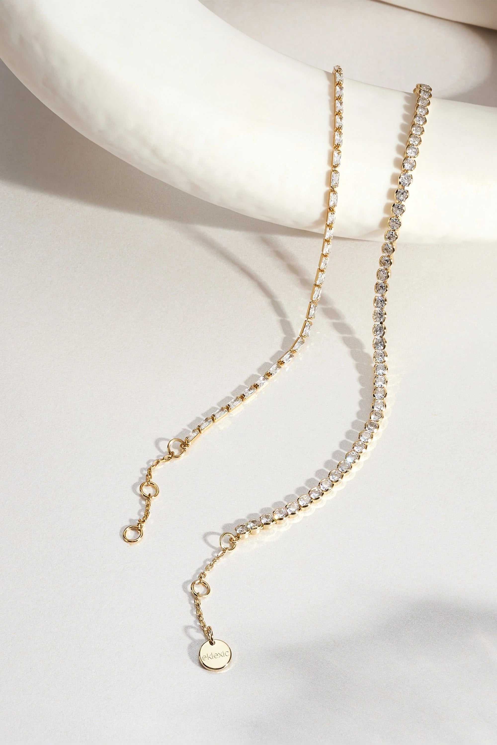 Two delicate gold necklaces showcased in the Baguette CZ Tennis Bracelet product image
