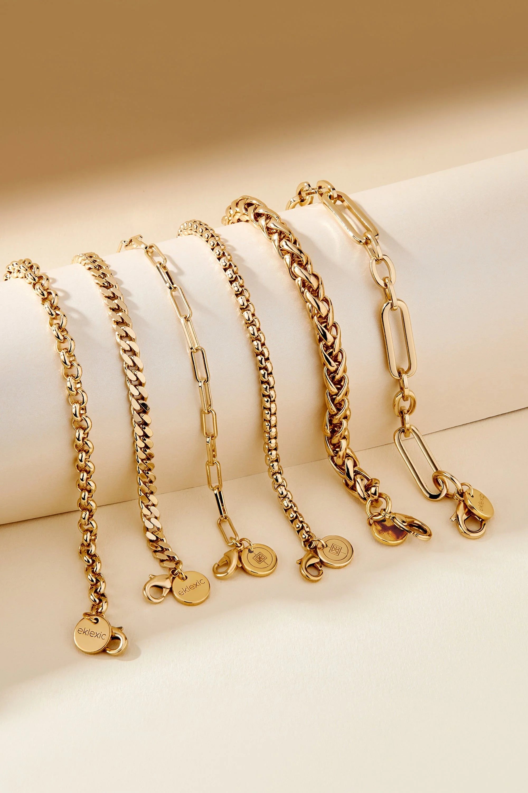Gold-toned Dean Bracelet with chain and circular charms on a stylish display