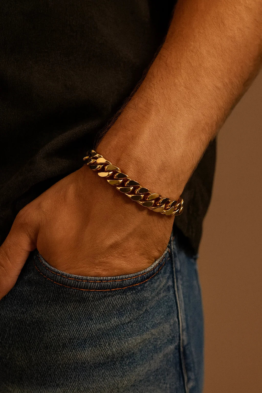 Men’s Curb Chain Bracelet featuring a thick gold-colored Cuban link on wrist