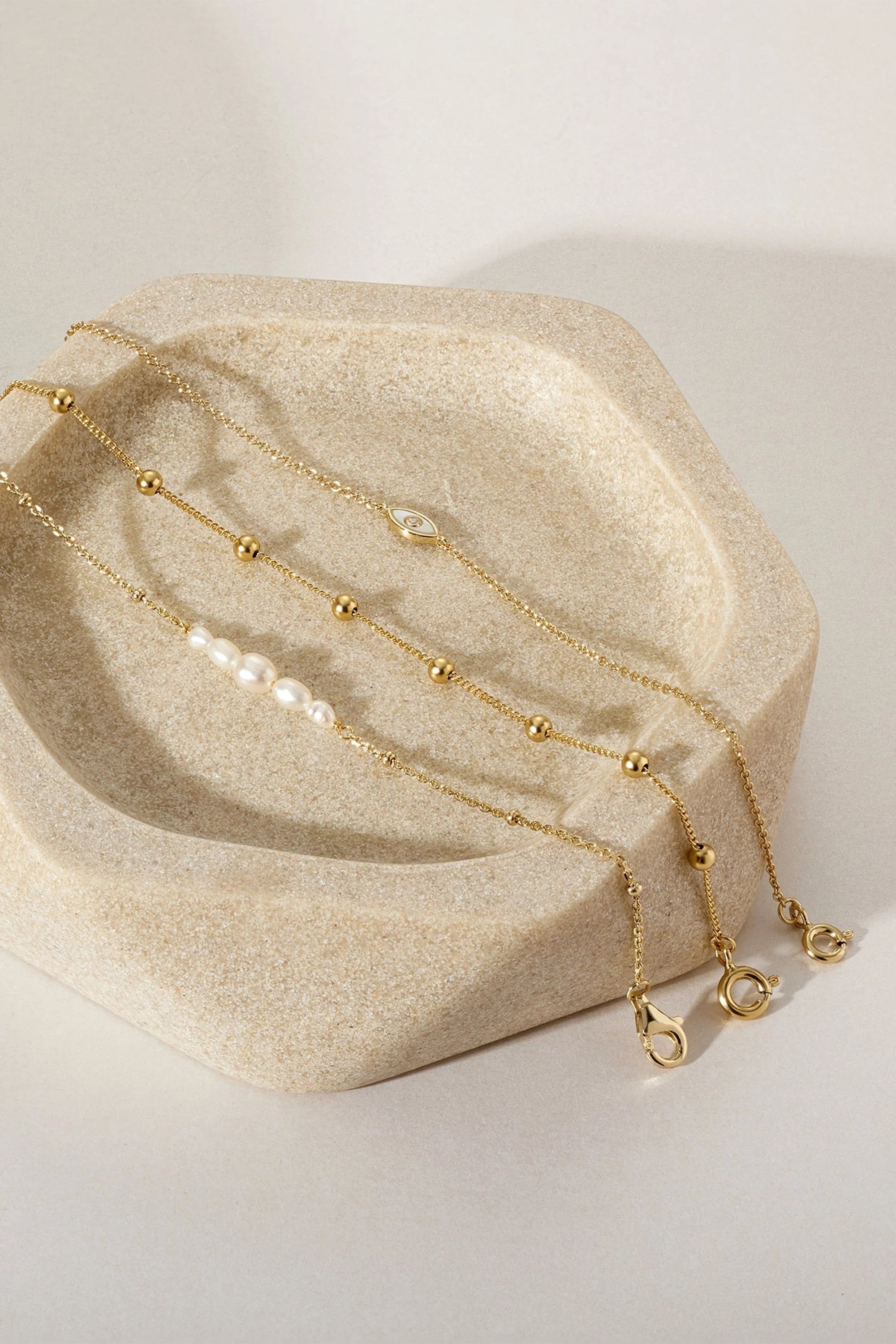 Delicate gold chains from the Micro Clustered Pearl and Bead Bracelet product