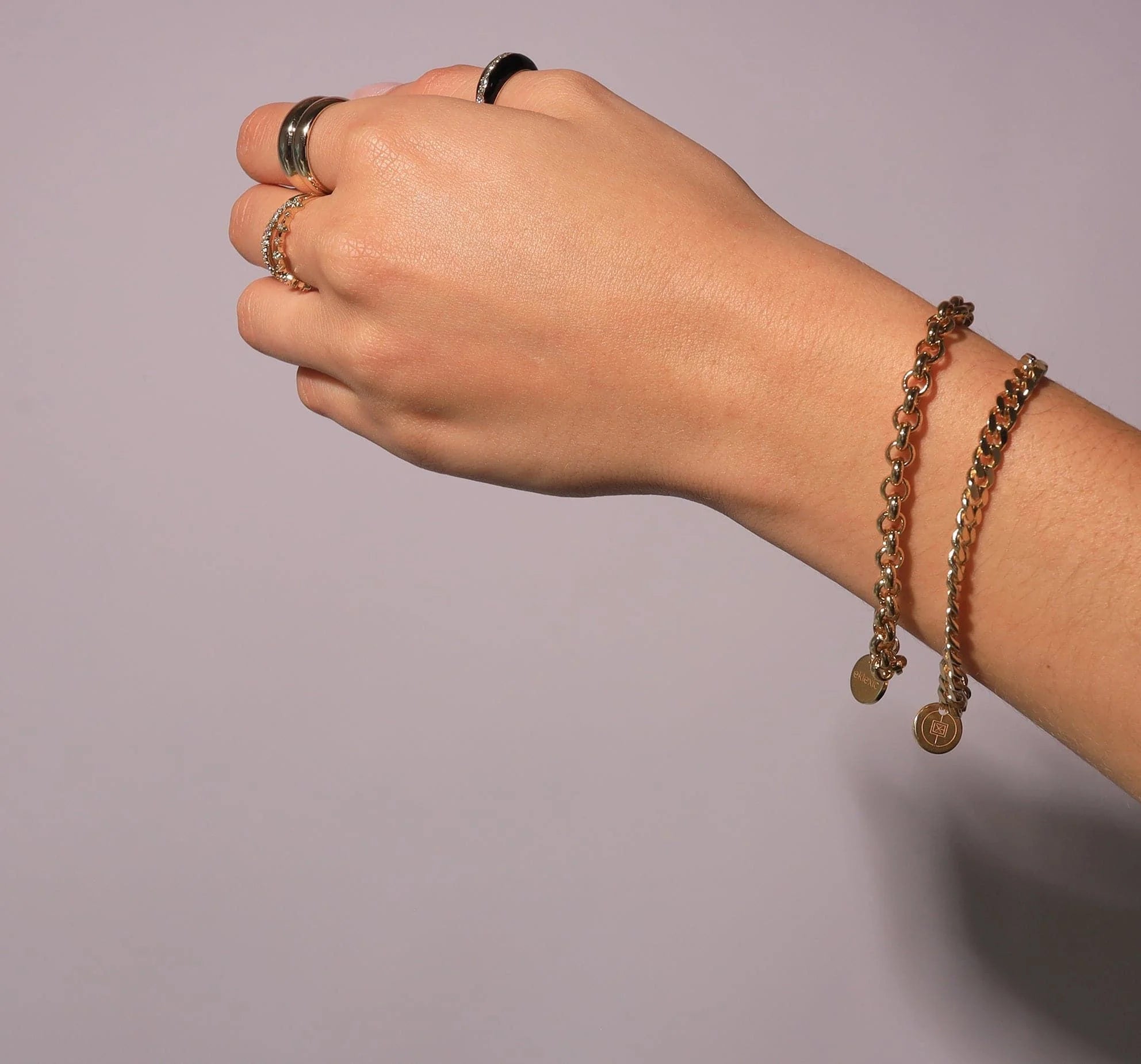 Hand with rings and bracelets wearing the Micro Royal Rolo Chain Bracelet