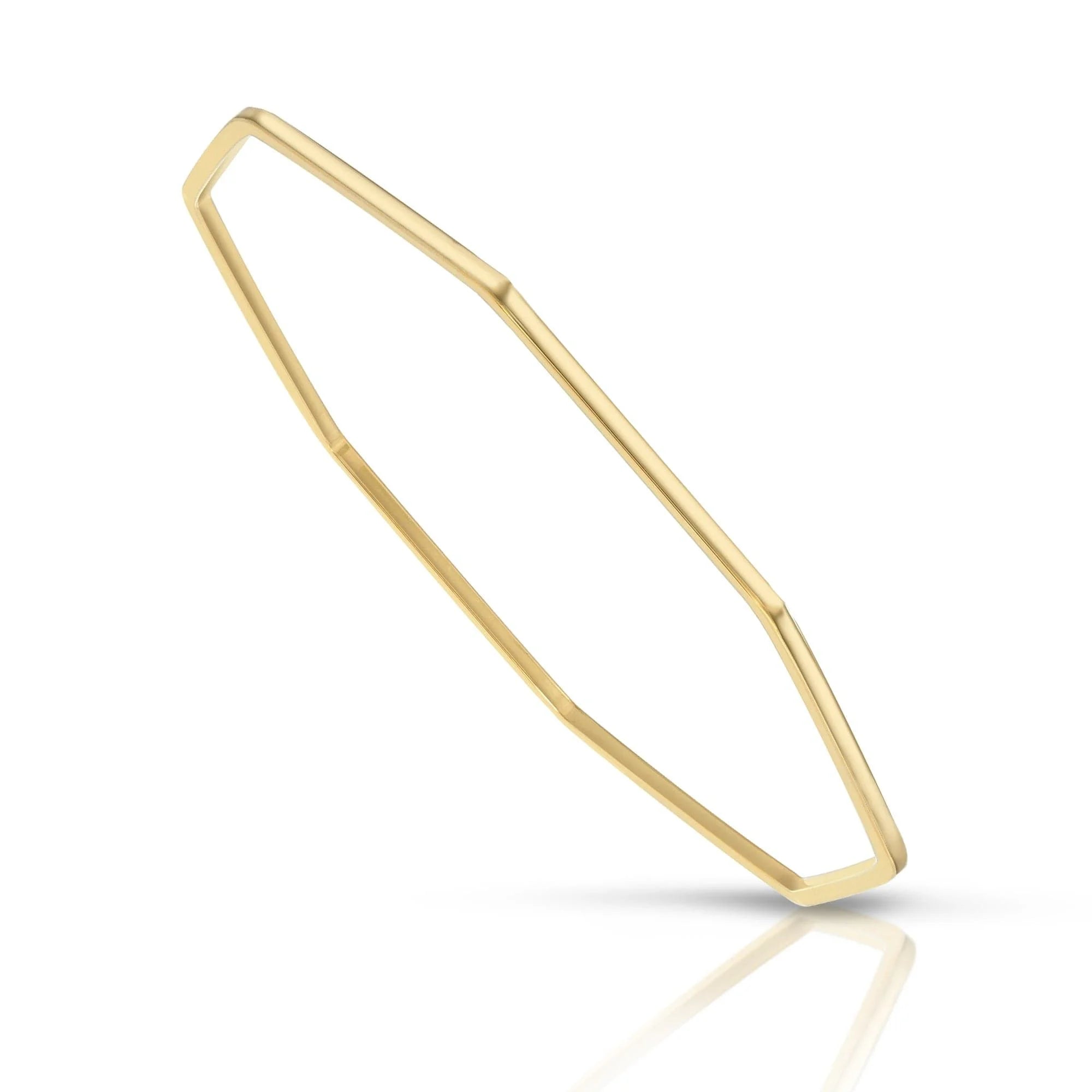 Shiny geometric gold Skinny Claire Bangle on a sleek jewelry display