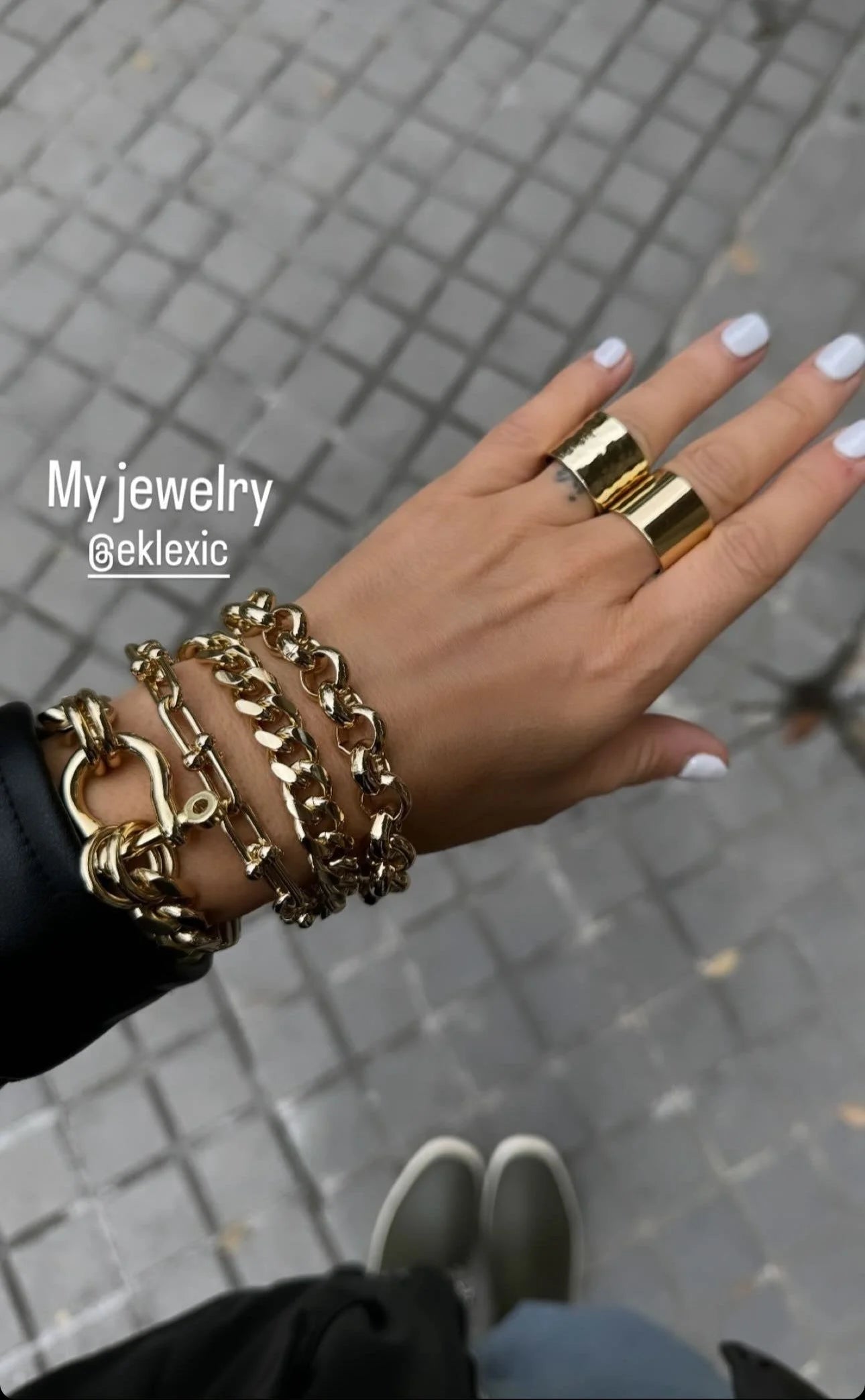 Gold jewelry on hand showcasing the stylish Violet Bracelet accessory