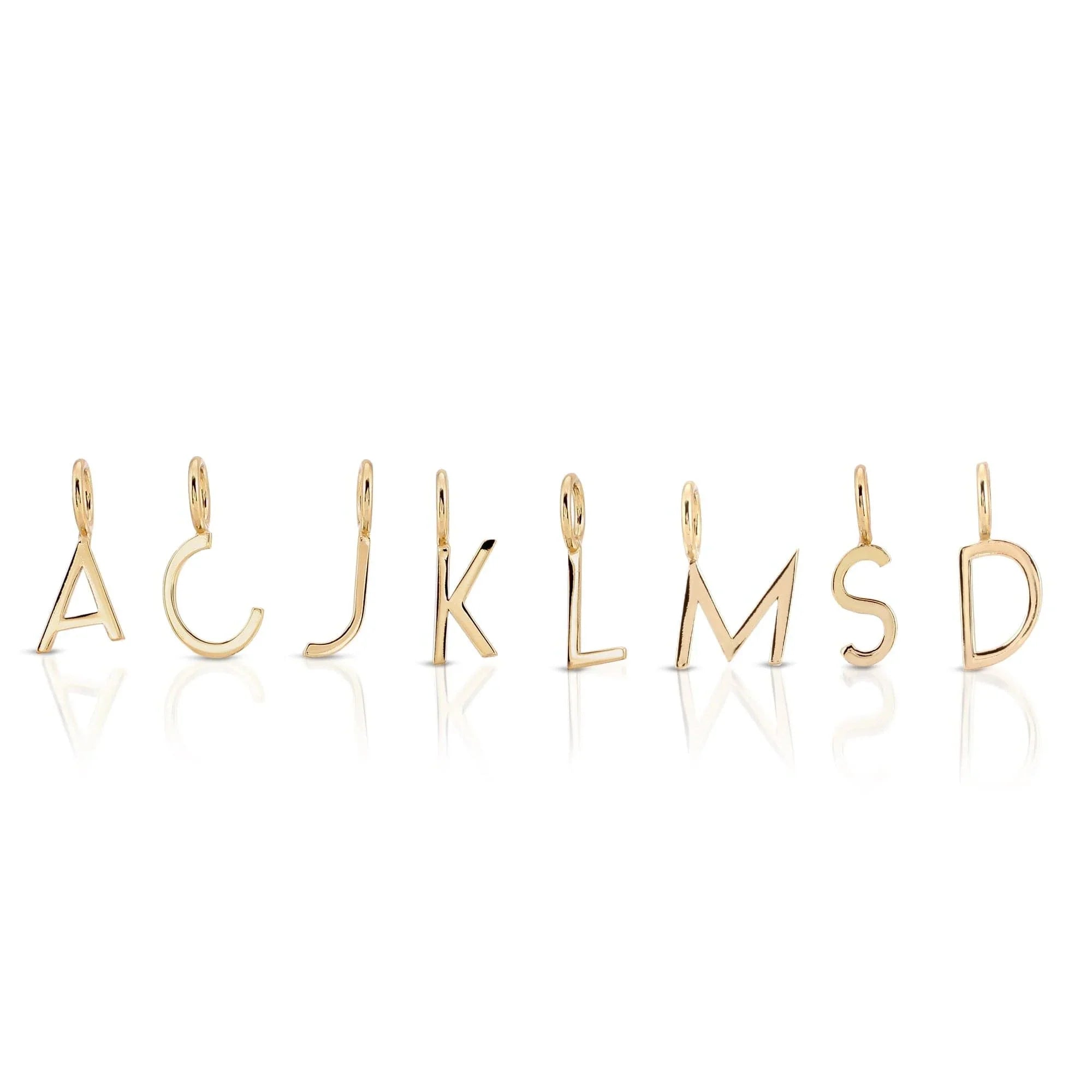 Gold letter pendants from Essential Letters hanging on a chain, perfect for personalized jewelry