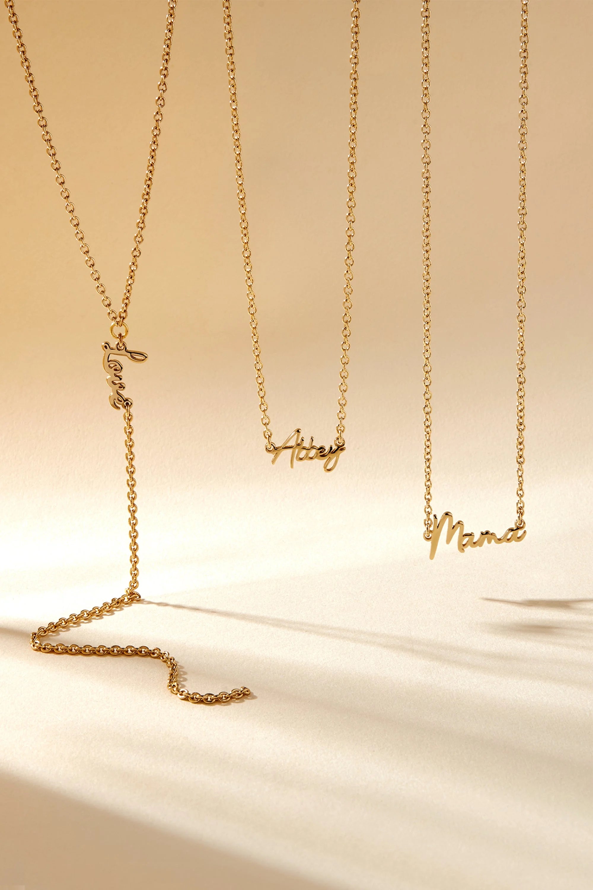 Gold nameplate necklaces on a Dainty Script Love Lariat Necklace for a stylish vibe
