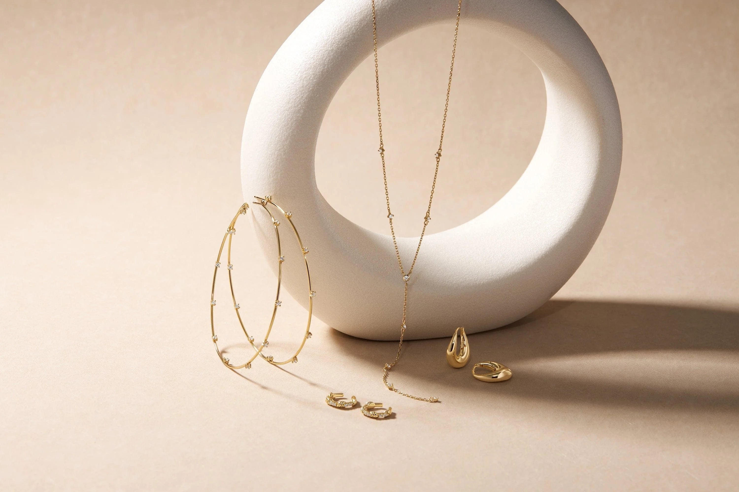 Beautiful gold jewelry set featuring CZ studded thin oversized hoops