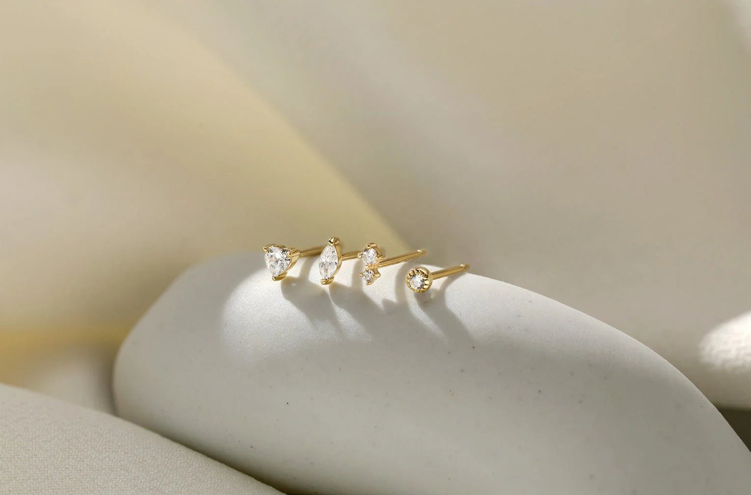 Four gold Heart CZ Stud Earrings with clear gemstones perfect for a cute look