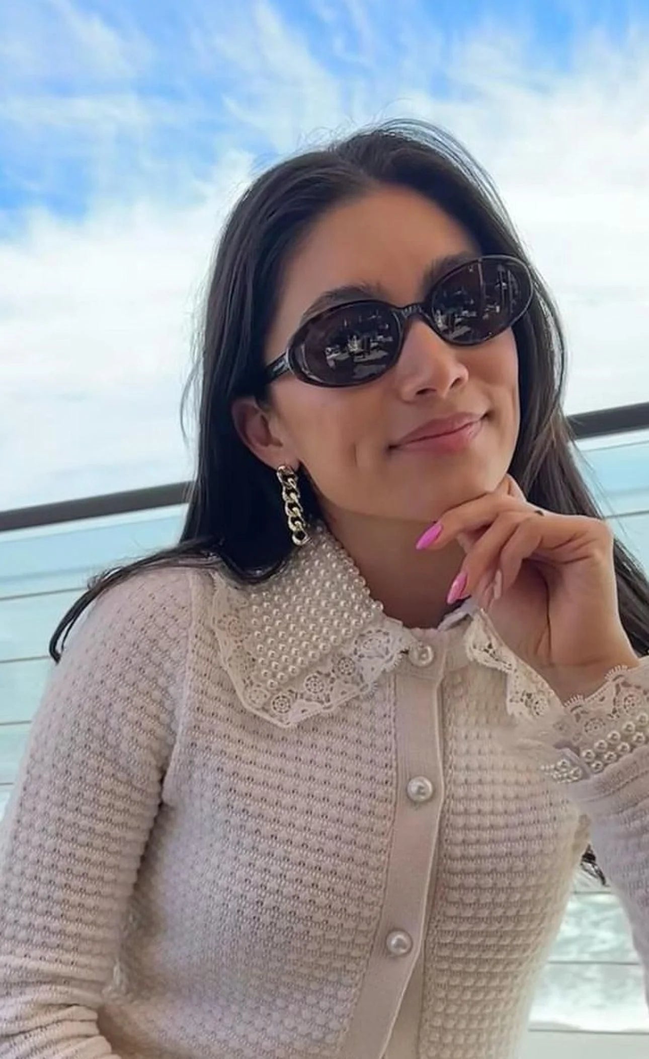 Woman in sunglasses and pearl cardigan wearing Taraji 5 Link Drop Earrings