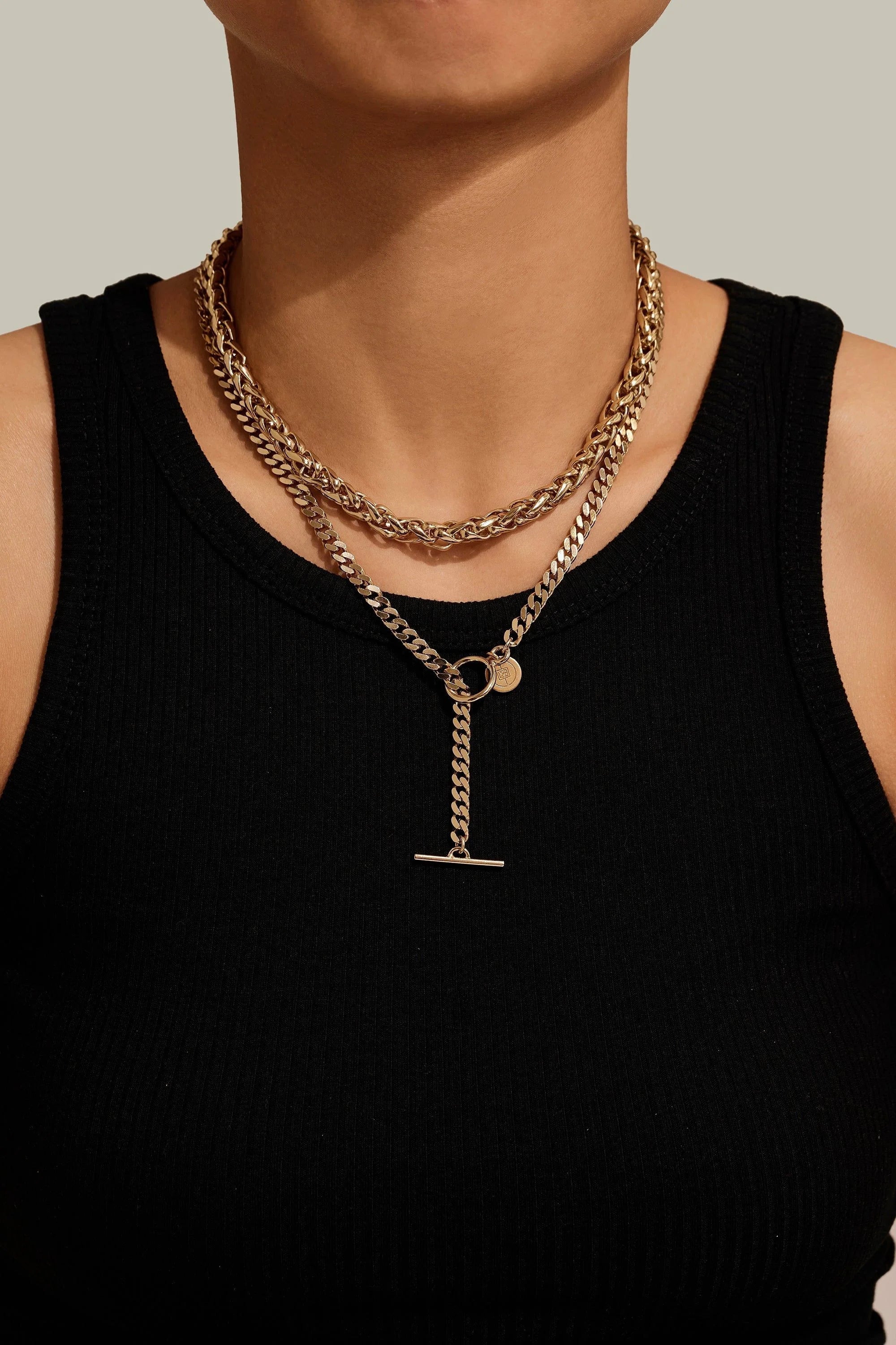 Gold-toned layered chain necklaces displayed on the Esmé Necklace product