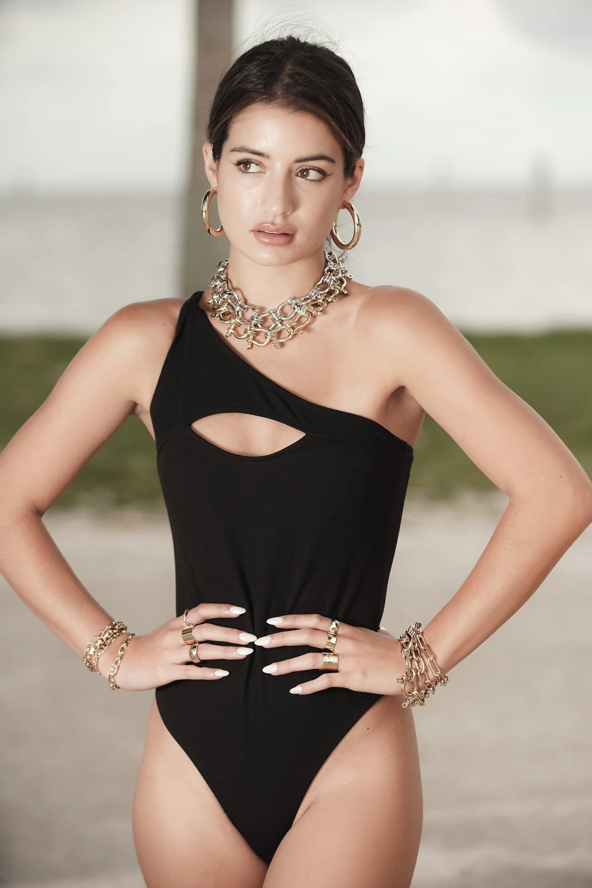 Black one-shoulder swimsuit paired with Harrison Necklace for chic summer look