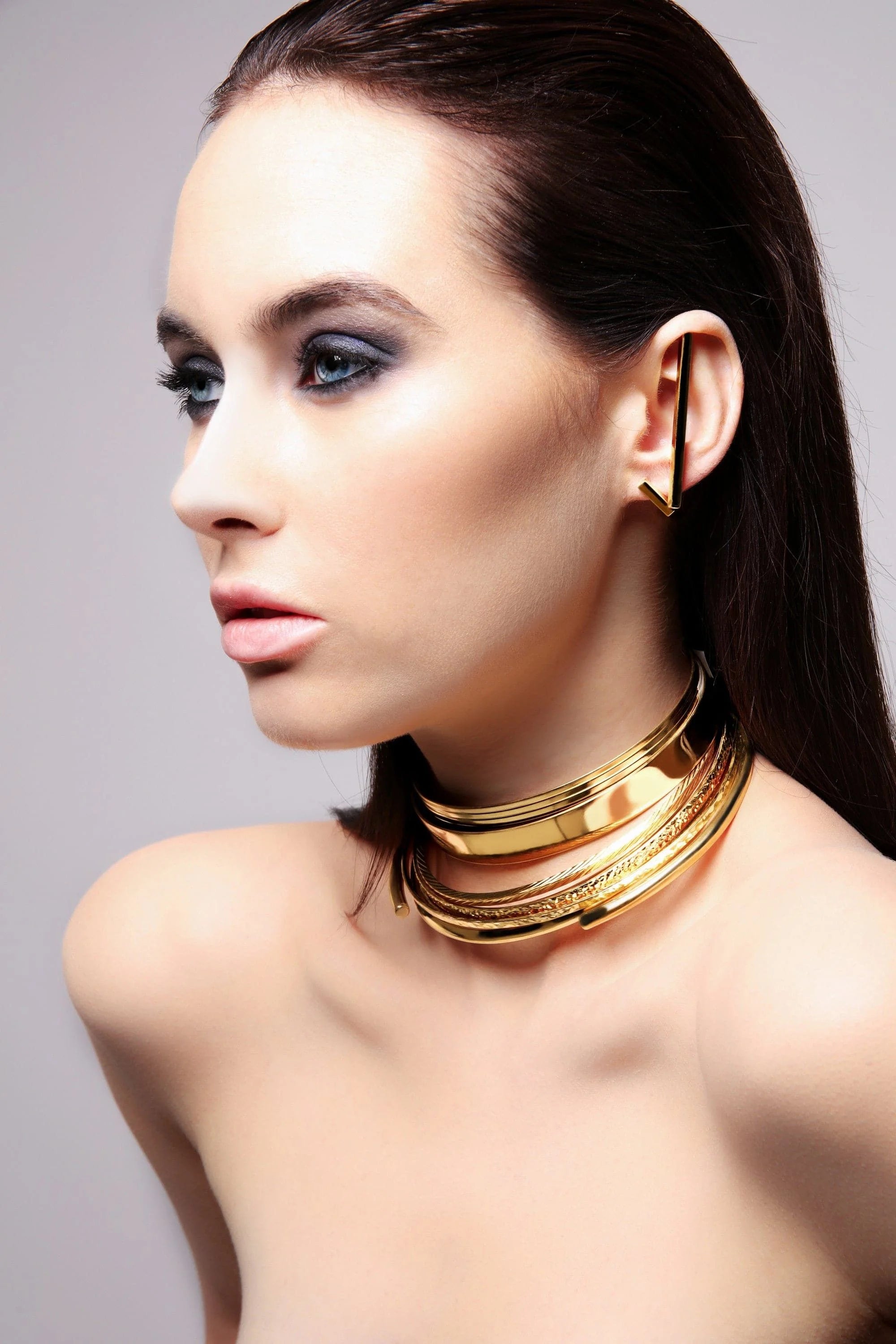 Golden layered choker necklace displayed in a product called Large Stick Earrings