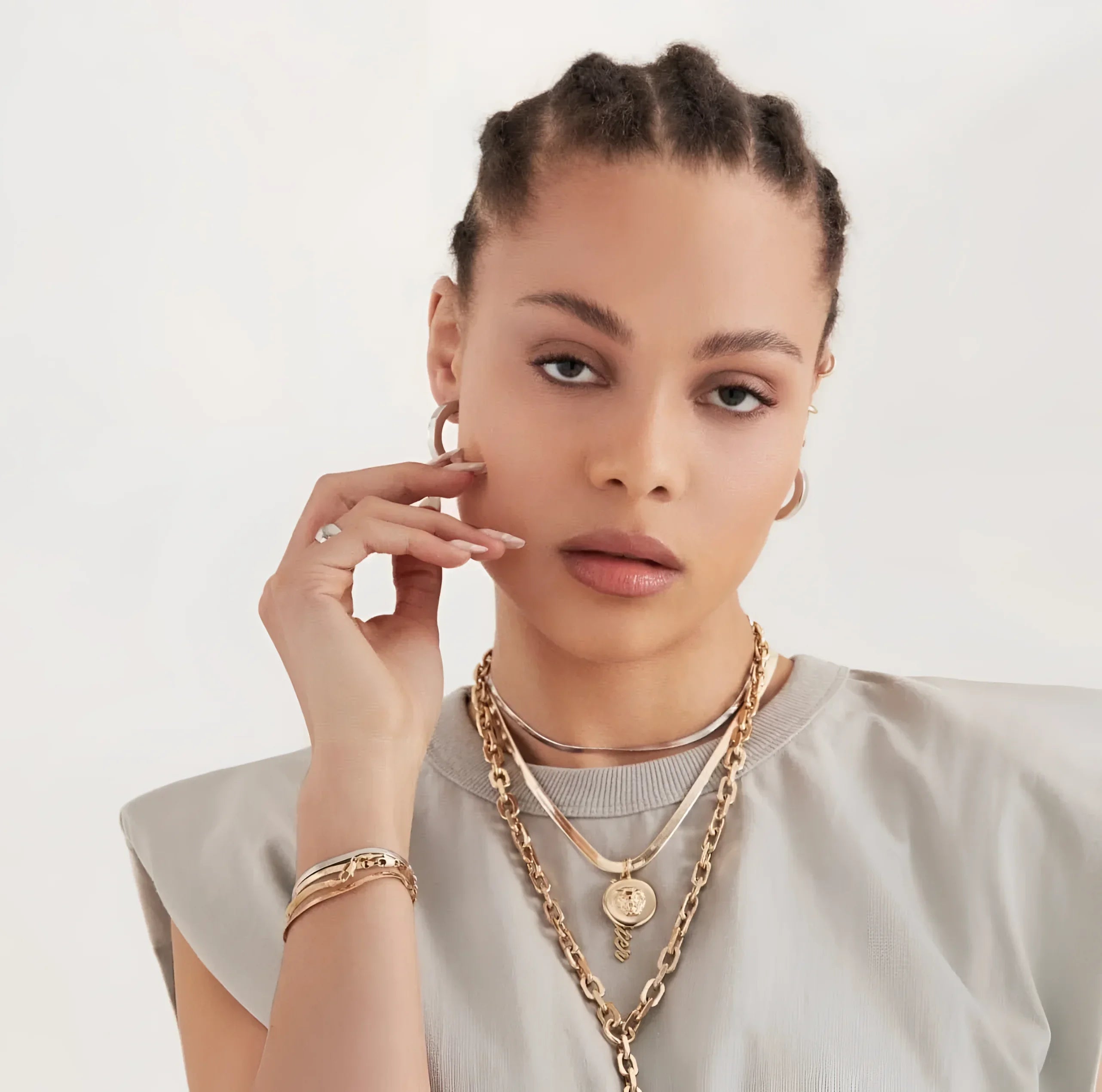 Woman wearing stunning gold jewelry showcasing the Melissa Pendant Necklace