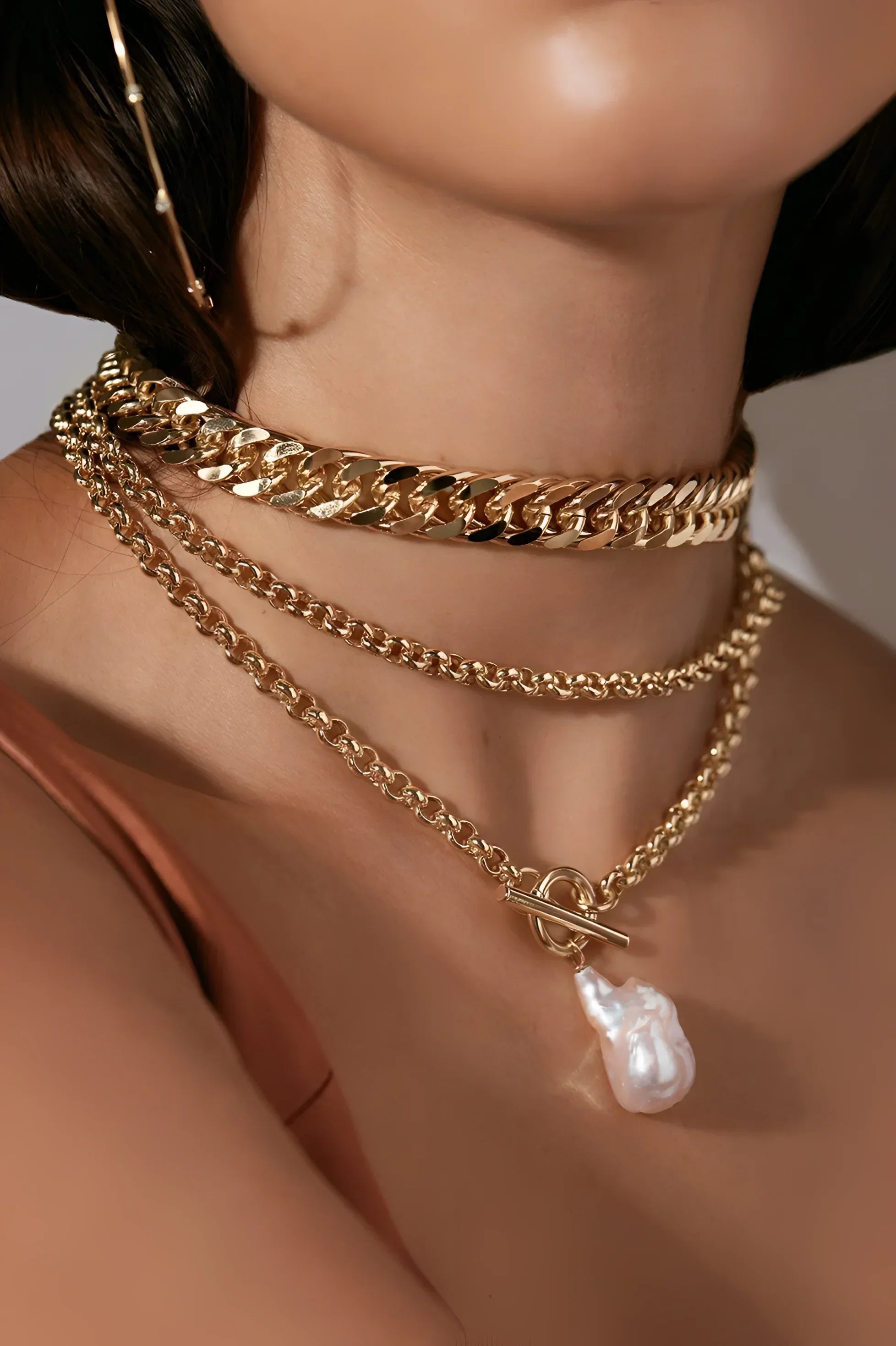 Arya Necklace featuring layered gold chains with a baroque pearl pendant