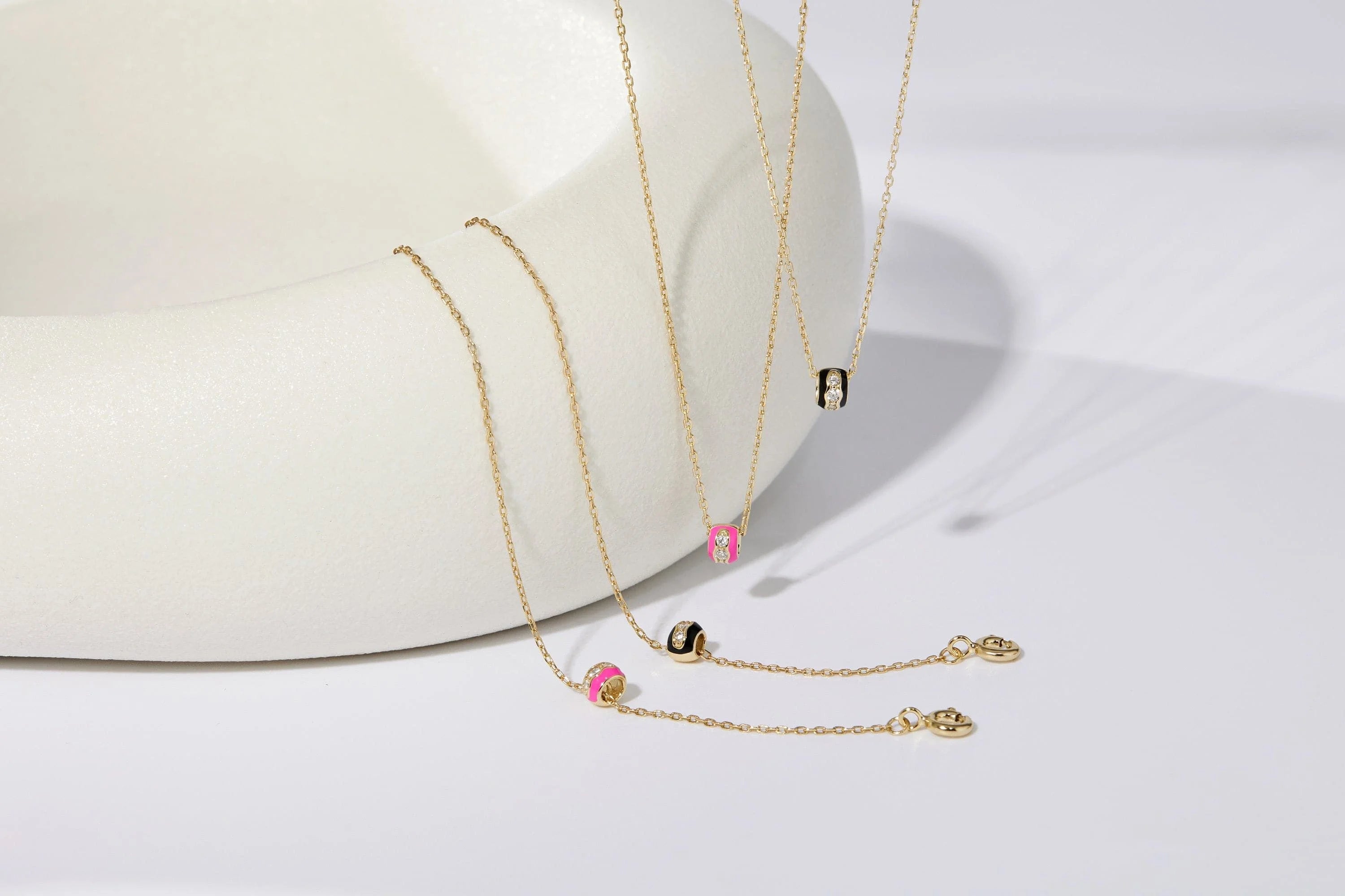 Gold necklaces with colorful cylindrical pendants from Black Enamel & CZ Channel Rondelle Necklace