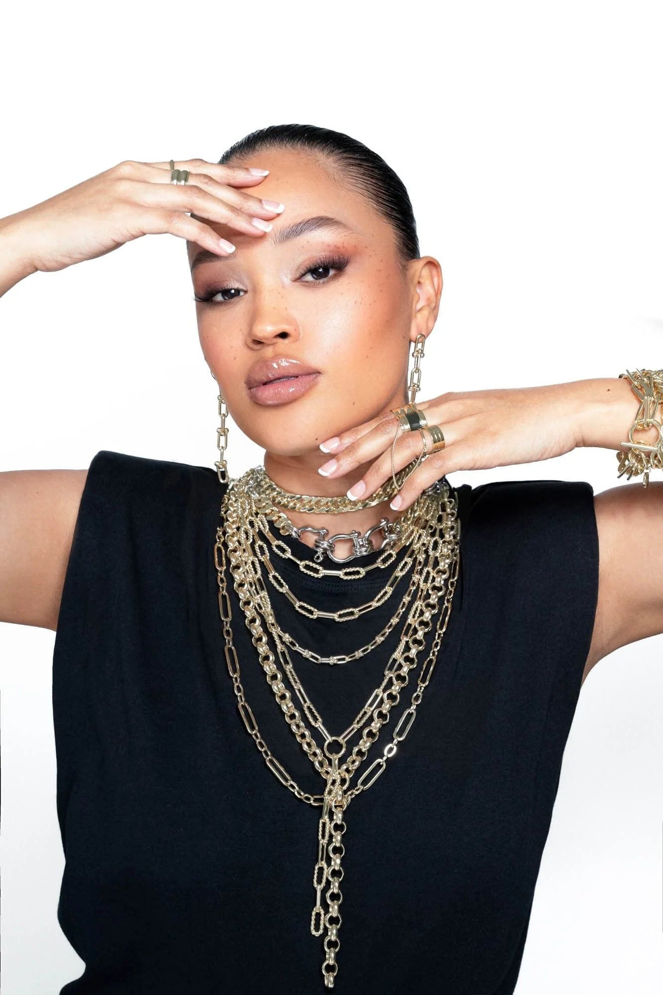 Woman wearing multiple gold necklaces showcasing the Enzo Double Layer Necklace