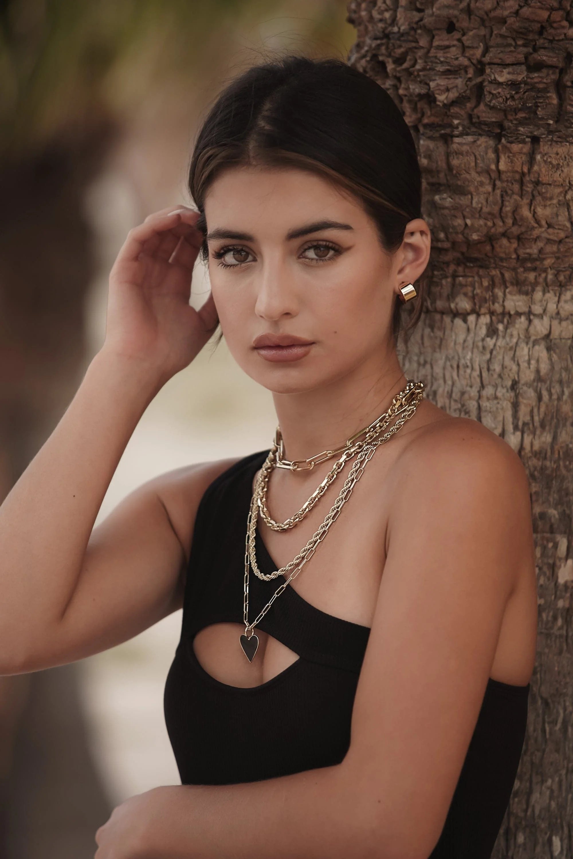Woman rocking the stylish Gianni Necklace with shiny gold layered chains