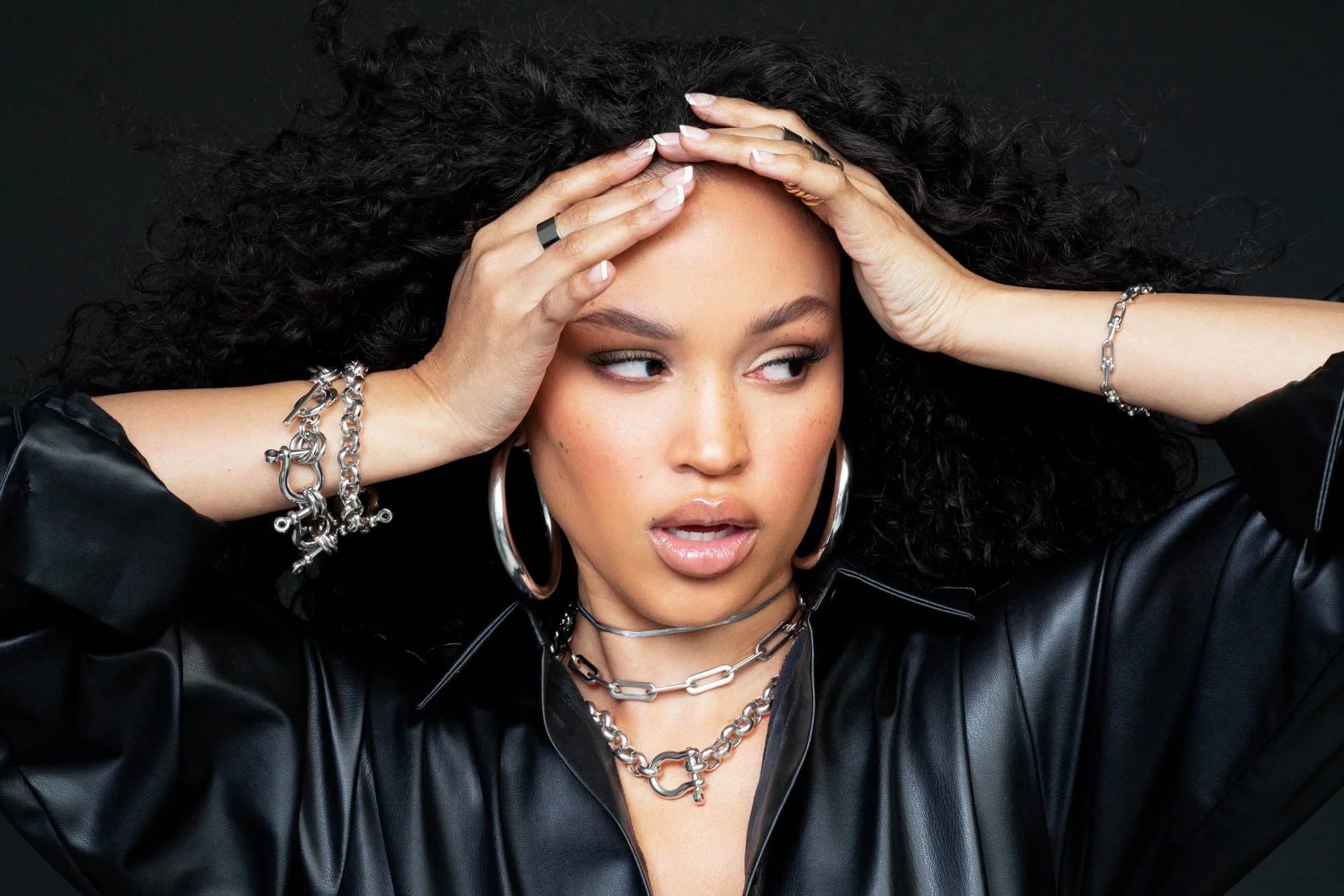 Woman showing off Harley Necklace with shiny silver jewelry style