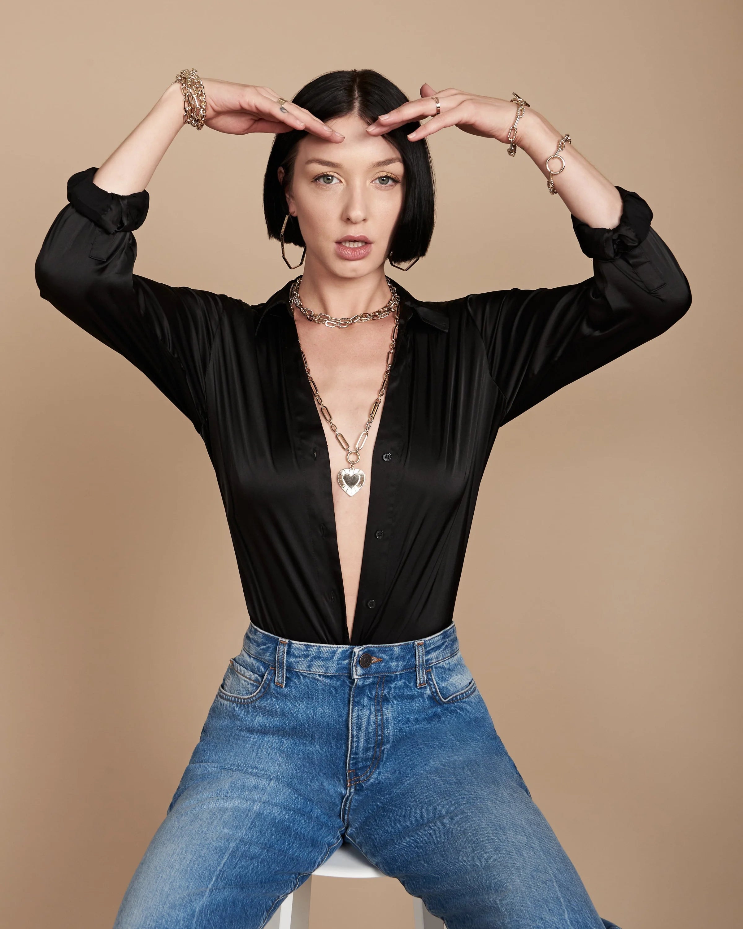 Woman wearing black shirt and jeans with Large Multi Link Chain & Heart Pendant Necklace