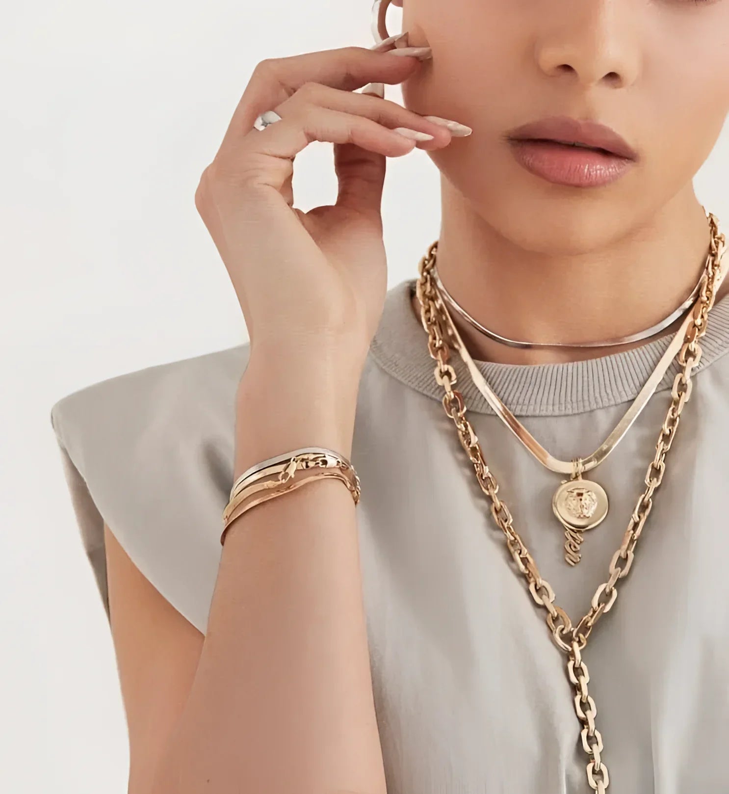 Woman wearing a stunning Lennon Lariat Necklace with gold jewelry for style