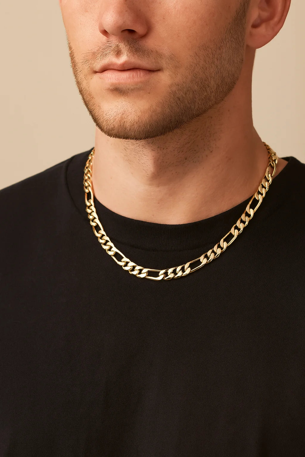 Gold-toned Figaro chain necklace on a man showcasing the Men’s Axel Necklace
