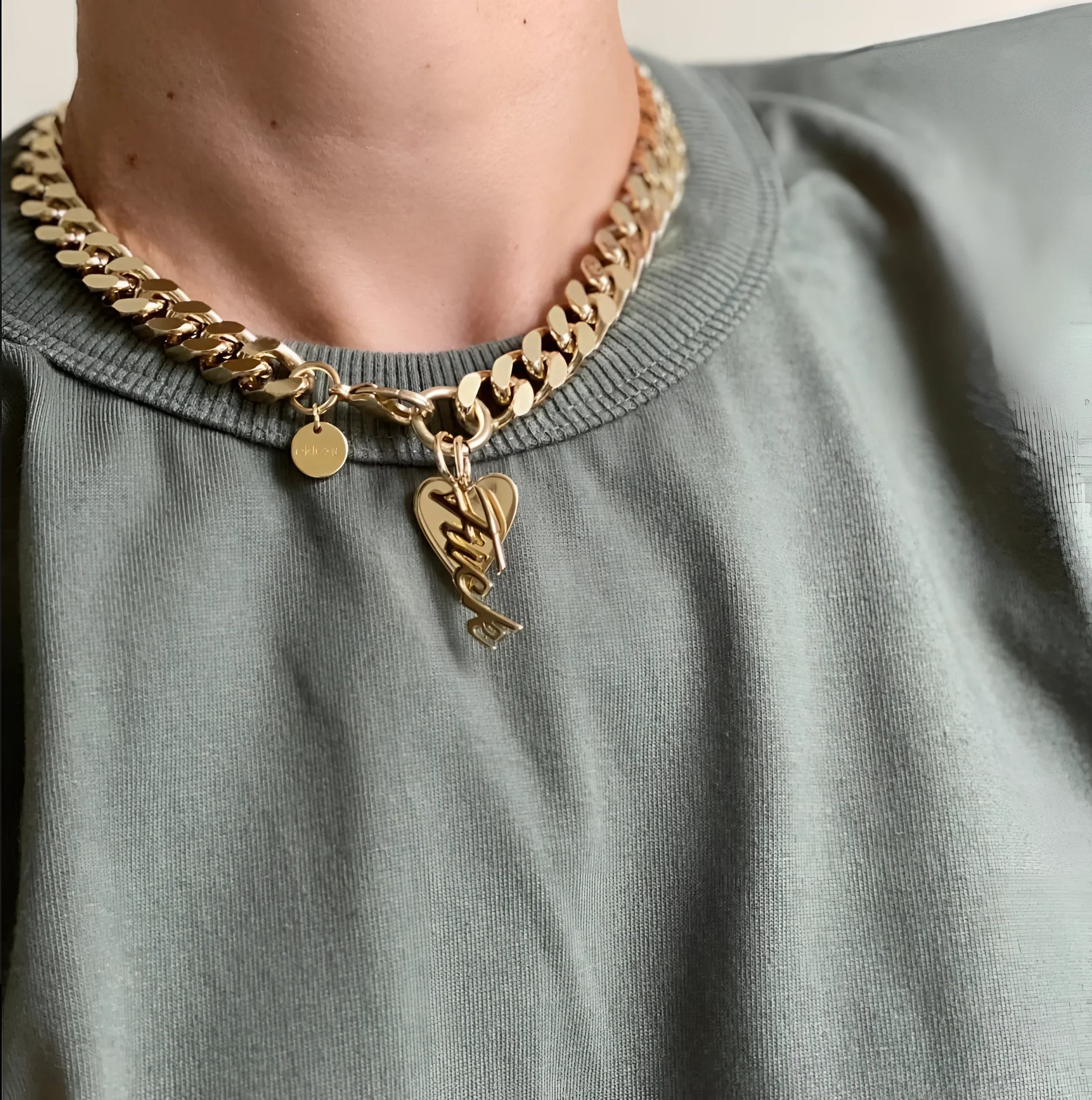 Gold chain necklace with heart pendant and fun charms in the Taraji Necklace collection