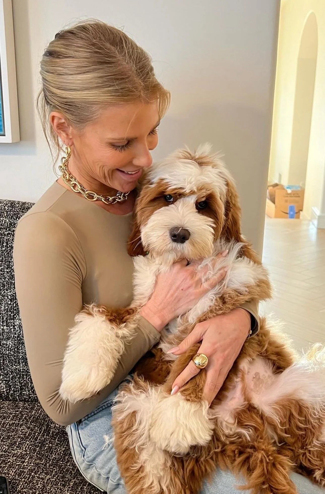 Woman holding a brown and white dog showcasing the XL Alternating Twisted Link Toggle Necklace