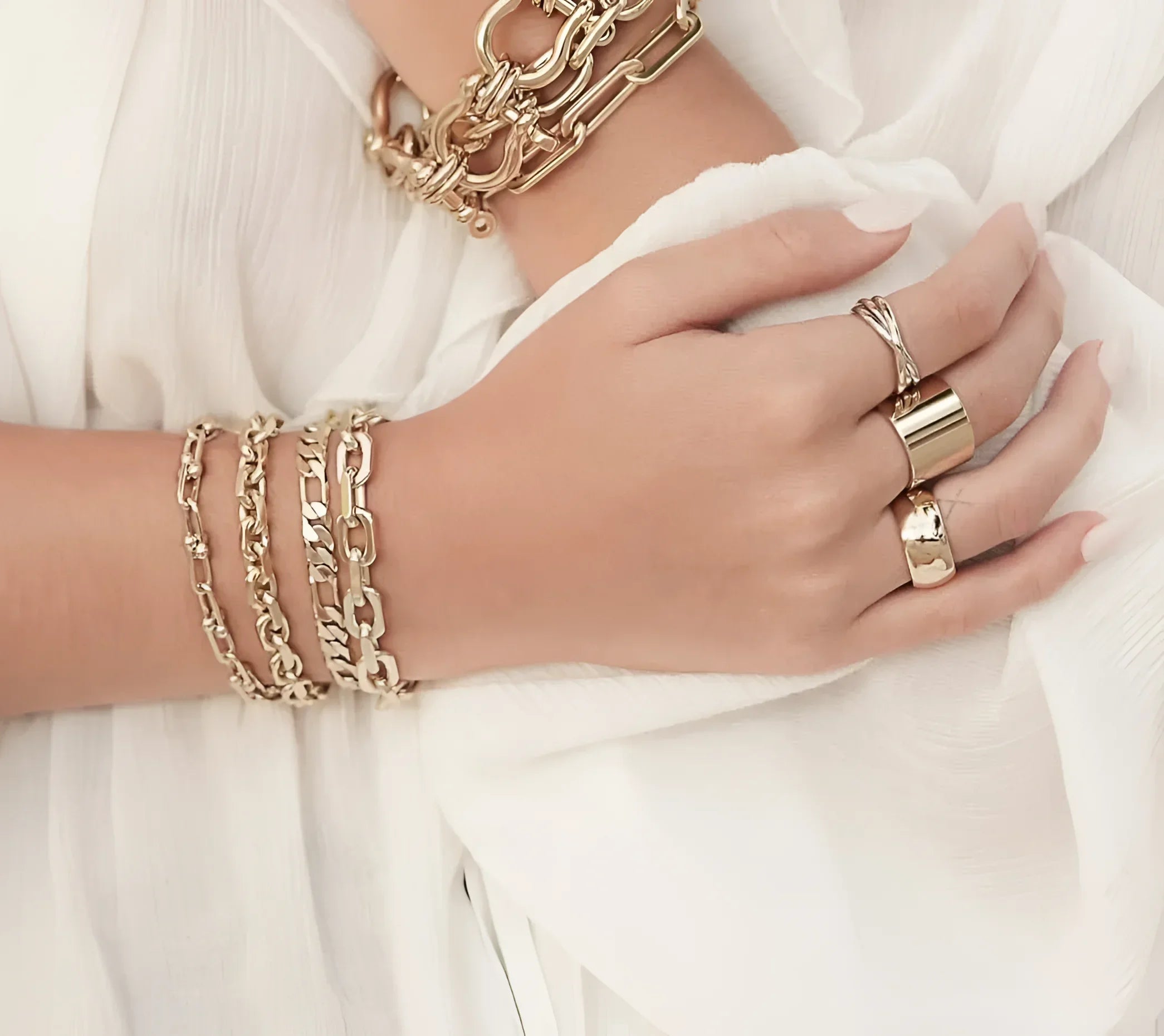 Gold-toned hand jewelry showcasing the Two Toned Triple Domed Roll Ring