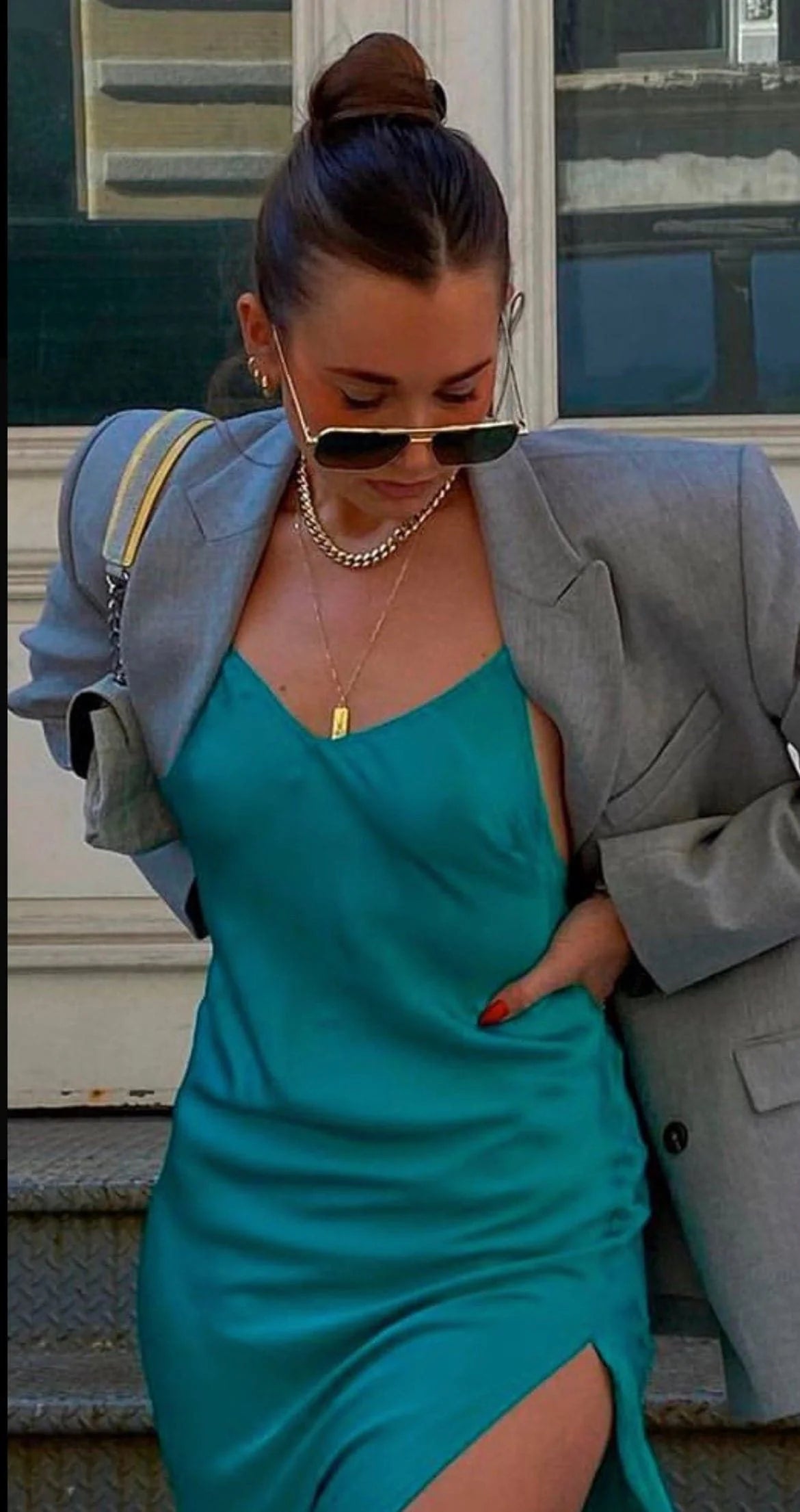 Woman in teal slip dress and gray blazer wearing Valentina Necklace stylish jewelry shot
