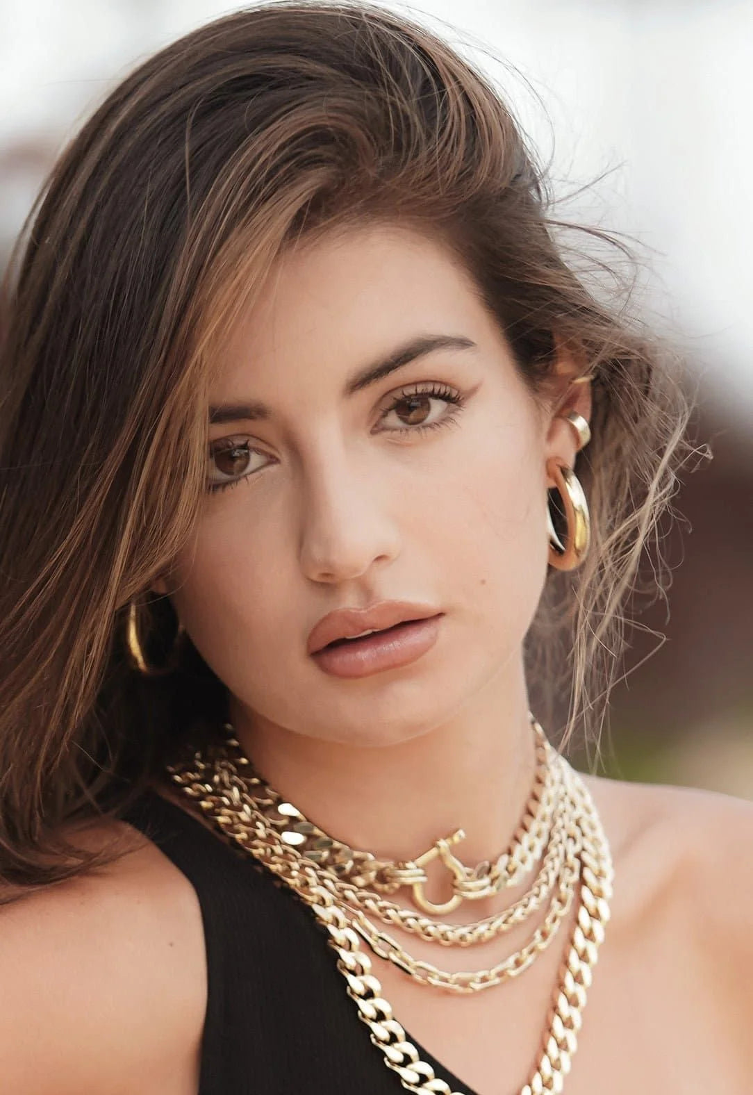 Woman wearing stylish Zolen Hoops gold jewelry, perfect for any outfit