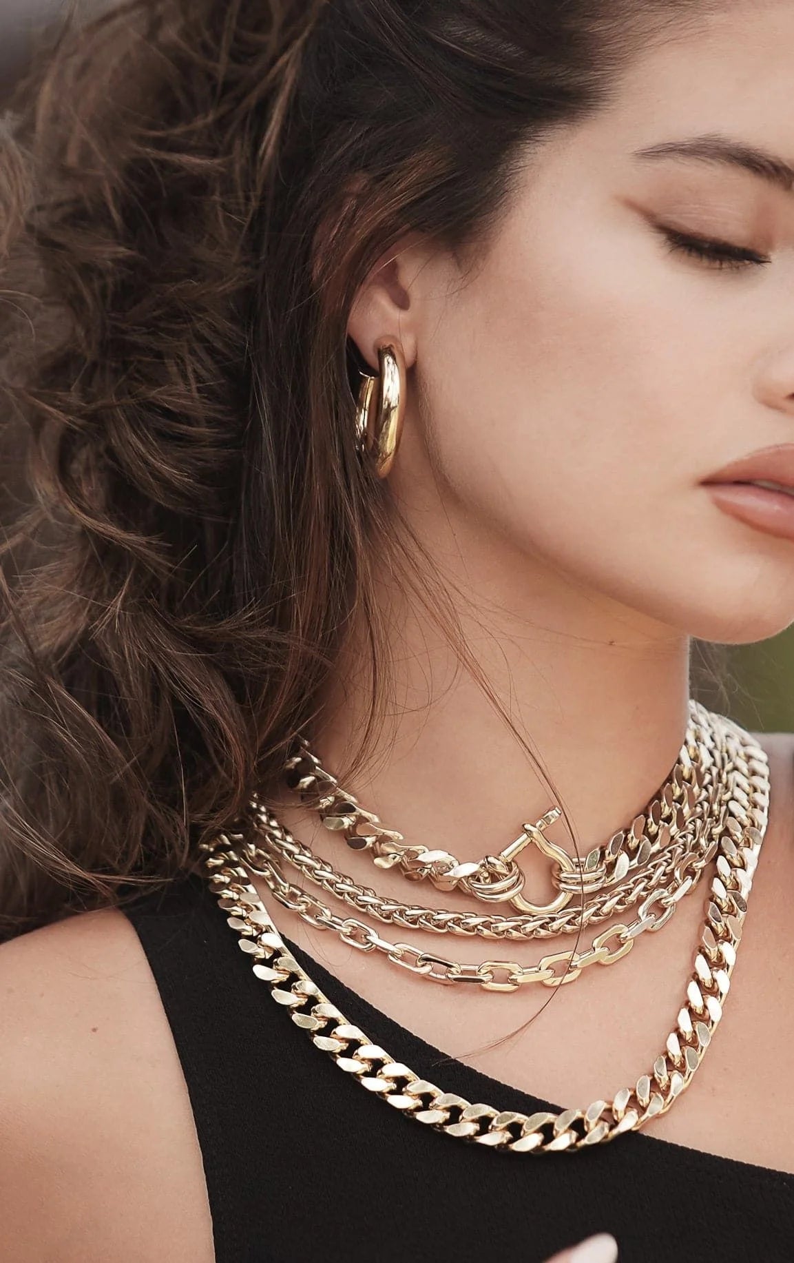Woman wearing elegant gold jewelry showcasing the Lennon Necklace product