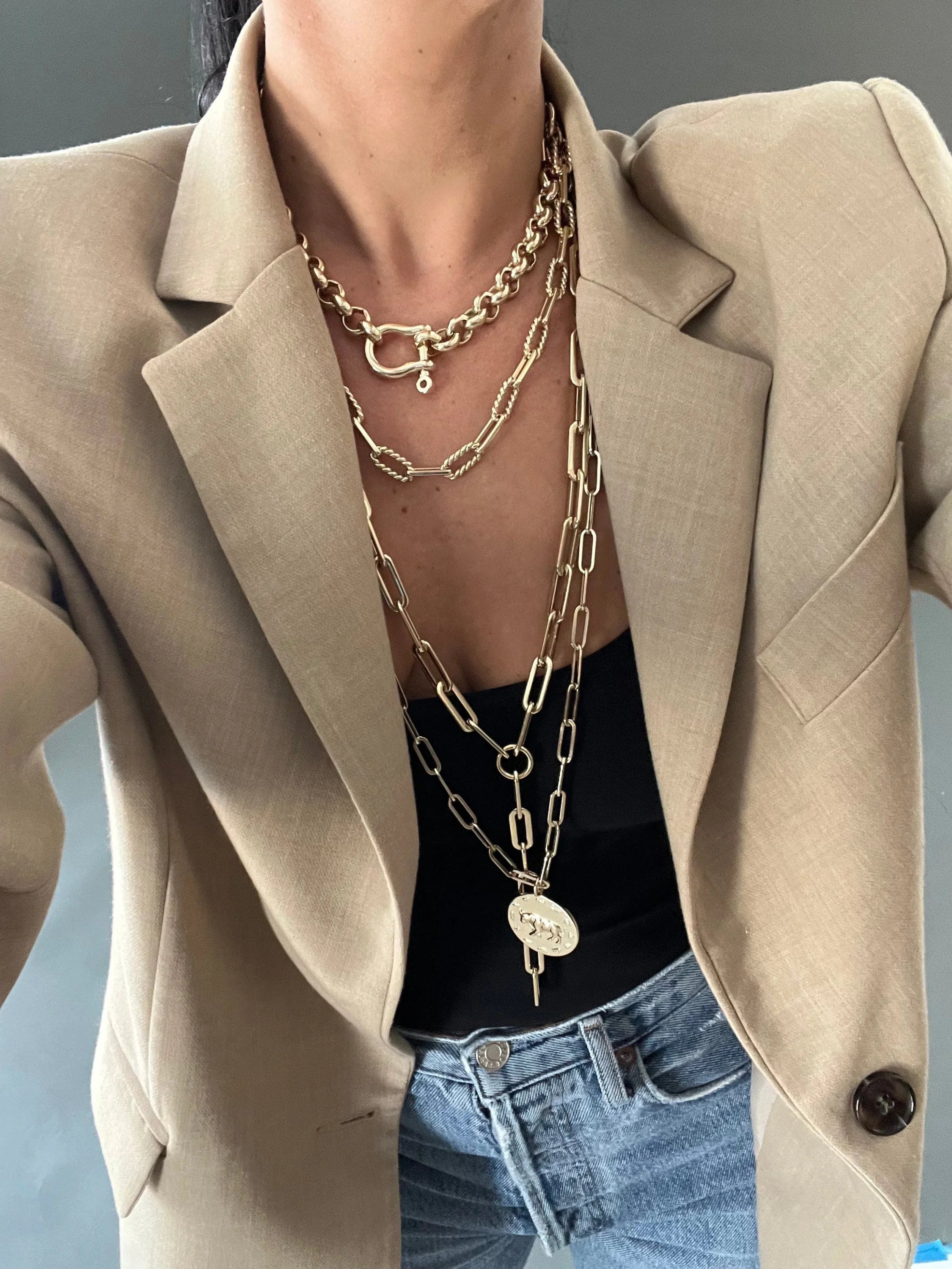 Layered gold necklaces featuring an extra large paperclip, Gisele Lariat with large brass paperclips